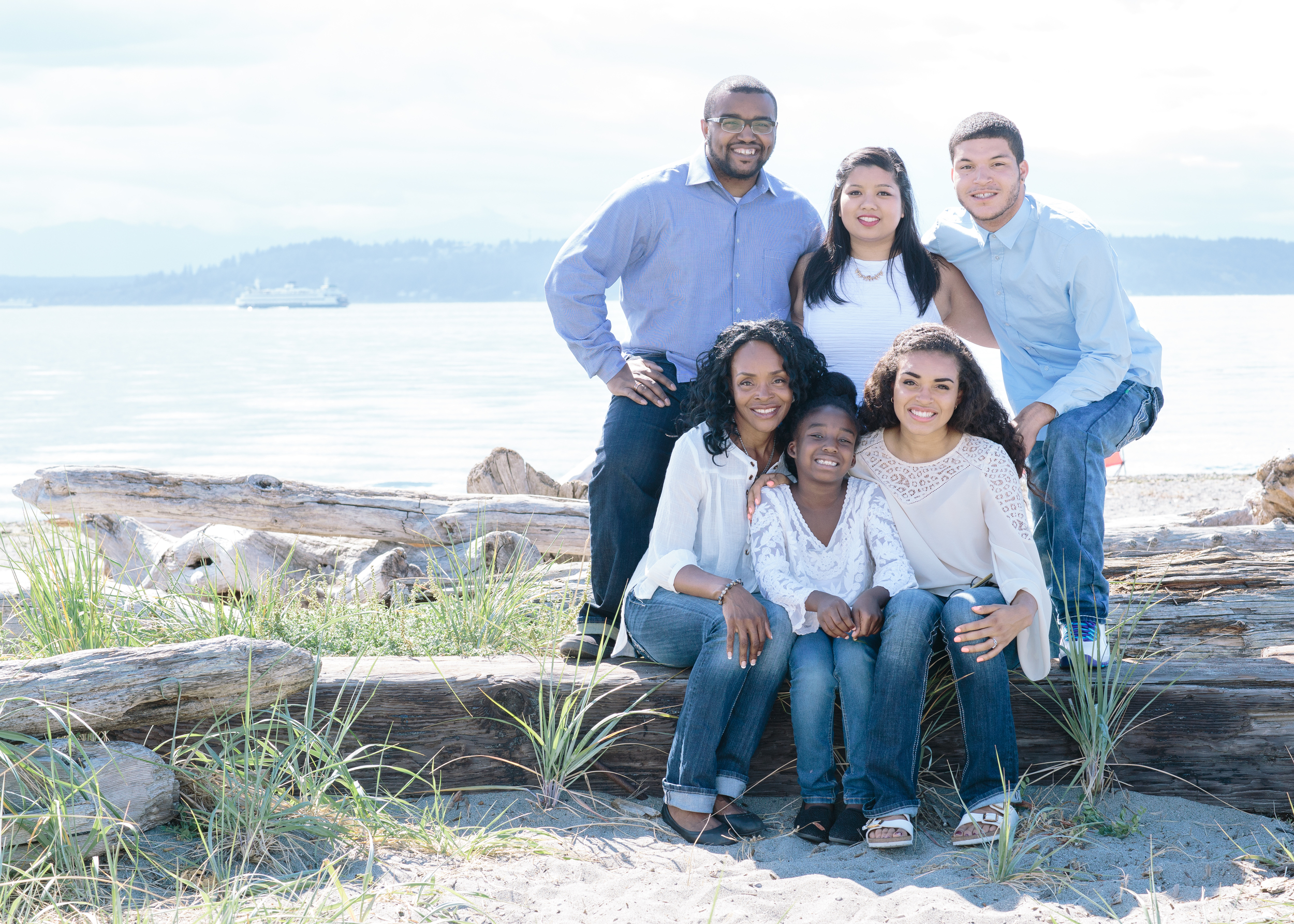 Here is a shot with the whole family included. I used my 35mm lens for this shoot which was perfect because I needed a wider angle to fit everyone nicely within the frame. I also captured the boats in the background from time to time which adds an even more beach-y feel to the set. 