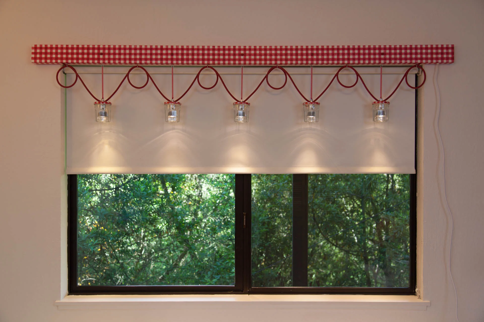  The hand-painted gingham valance hides the transformer, since she wanted to plug the light into an outlet rather than having it professionally installed. 