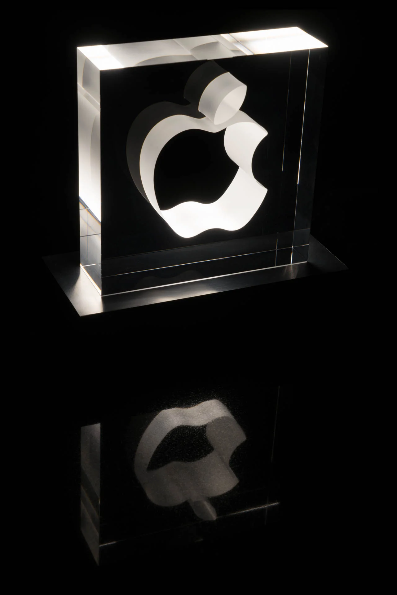  Strip LEDs in a simple aluminum pedestal keep the focus on the glowing glass. 