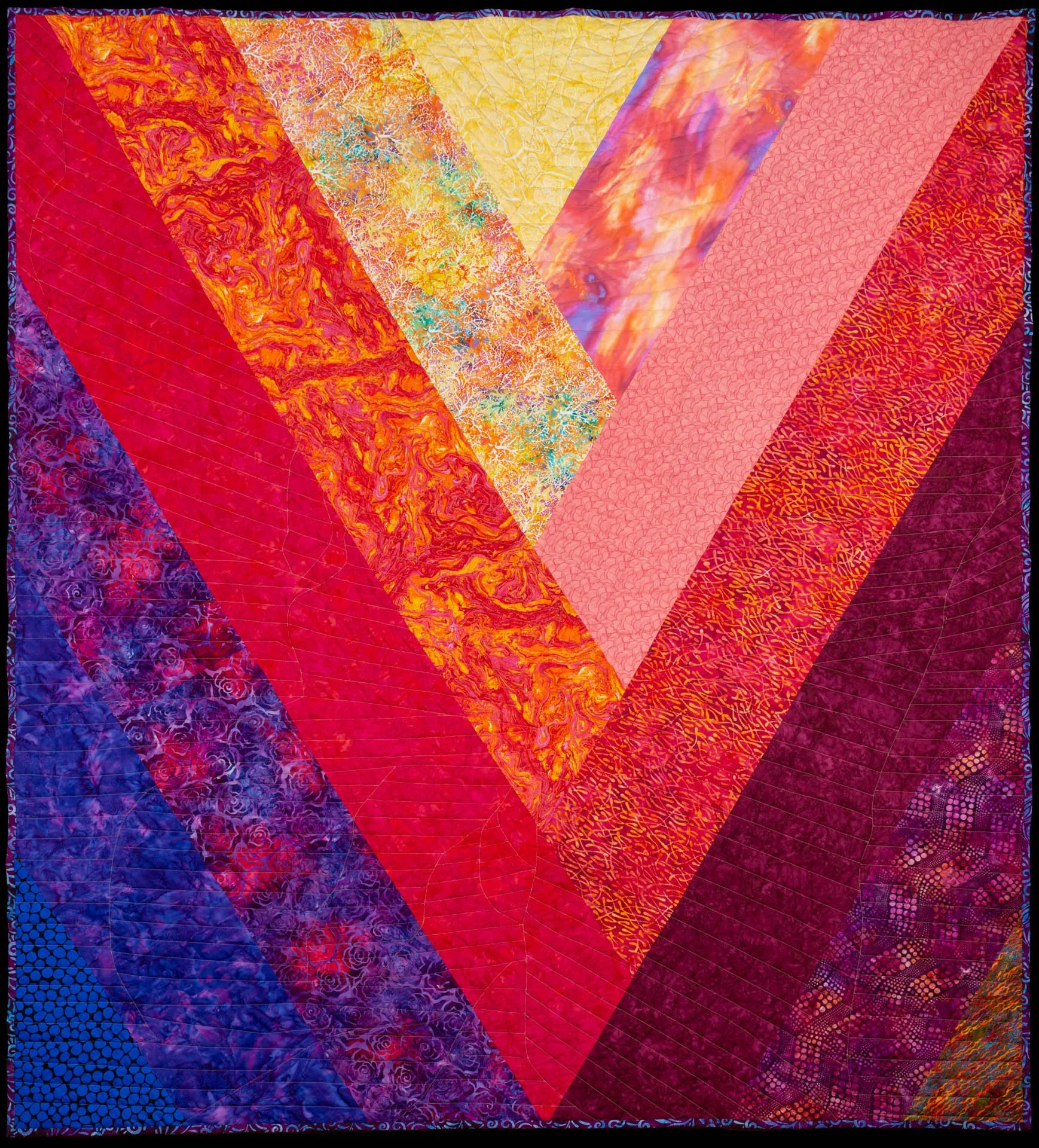  The back of the quilt uses similar colors in less complicated design. 