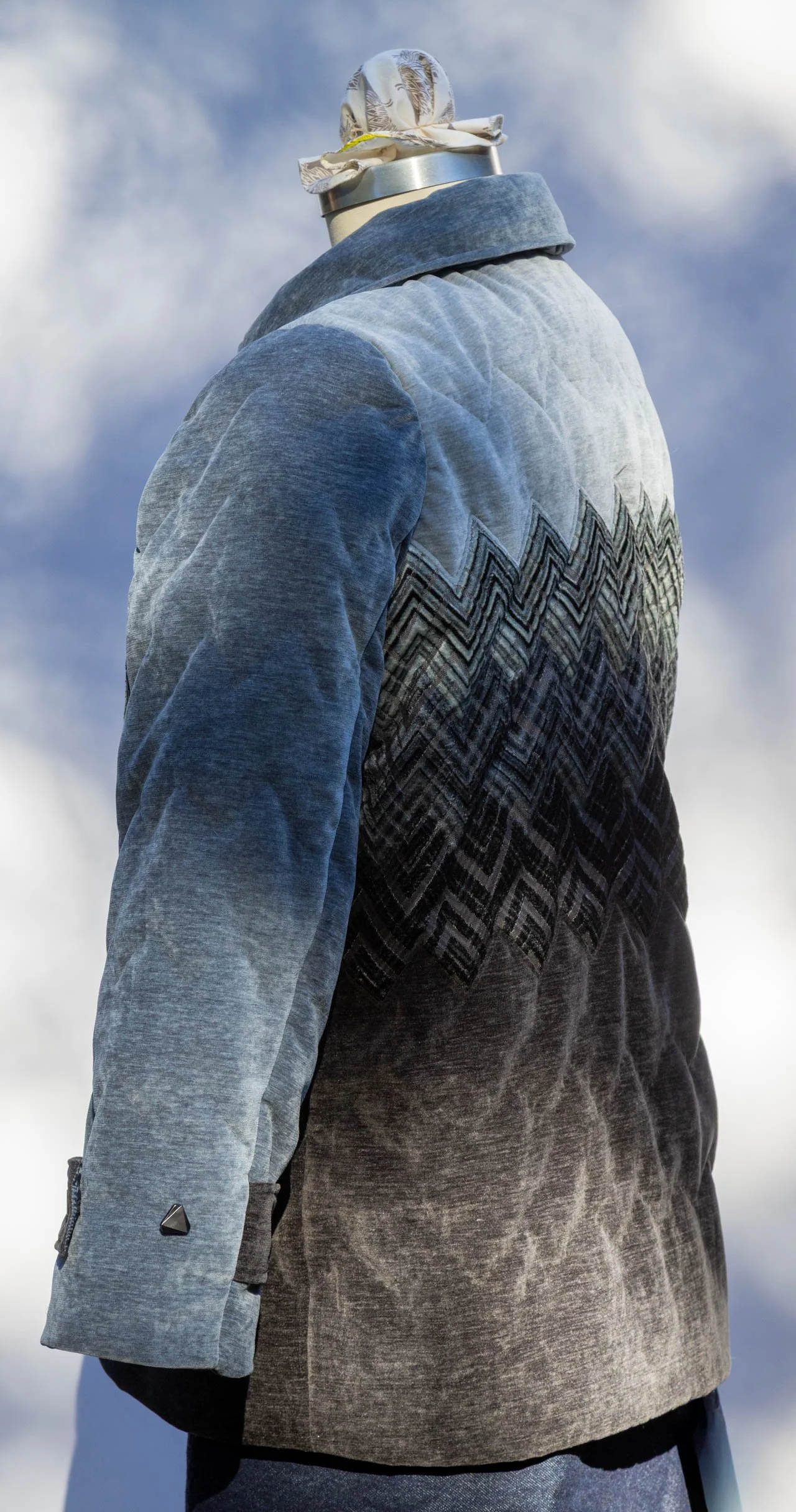  Zigzagged lines of hand-quilting secure all the layers and create a puffer look for the coat. 