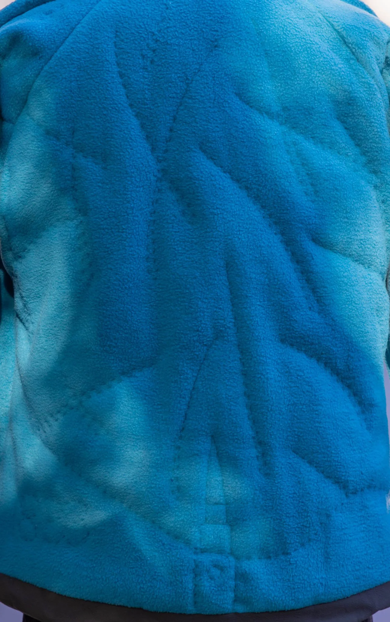  Primaloft needs to be secured, creating another opportunity for fun imagery.  Leonid showers came to mind, so I used a meteor shower motif as a guide for hand-quilting the batting to the fleece. 