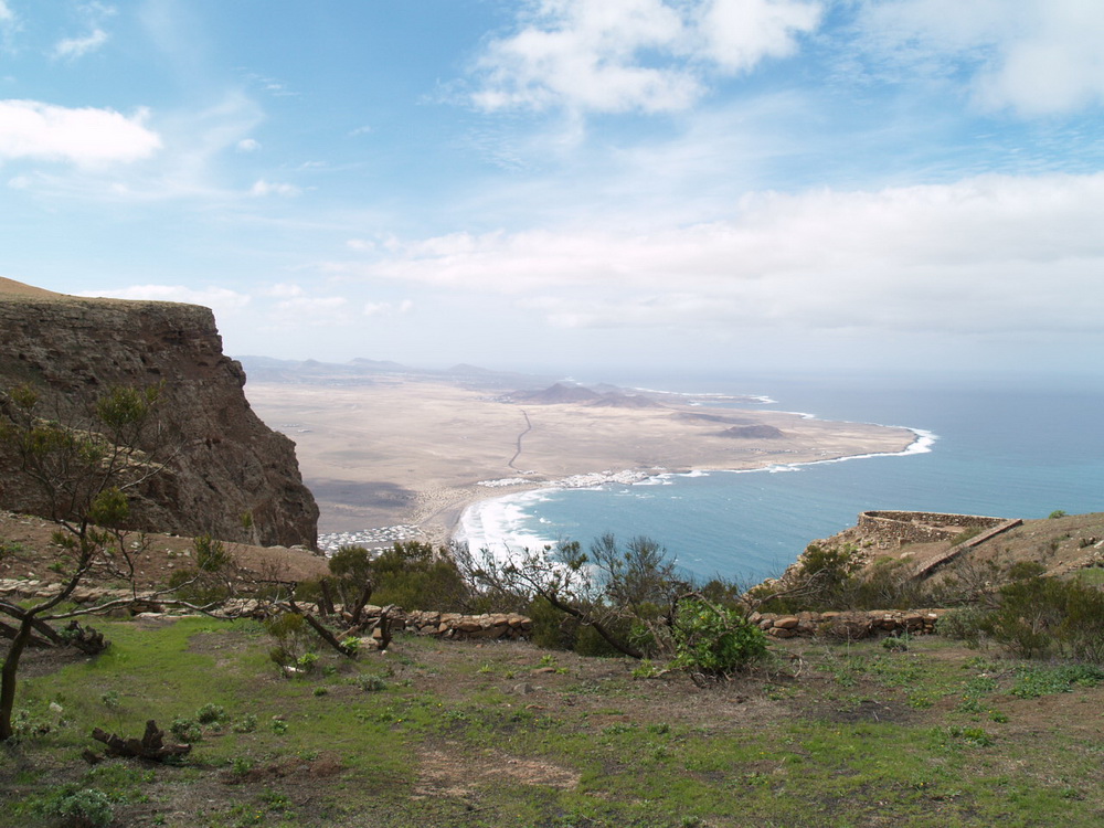 The Lanzarote Beach Apartmen t is located in the centre of this picture close to the stunning Famara bay, with Cliff and Island Vistas, ideal for a rural holiday or eco retreat