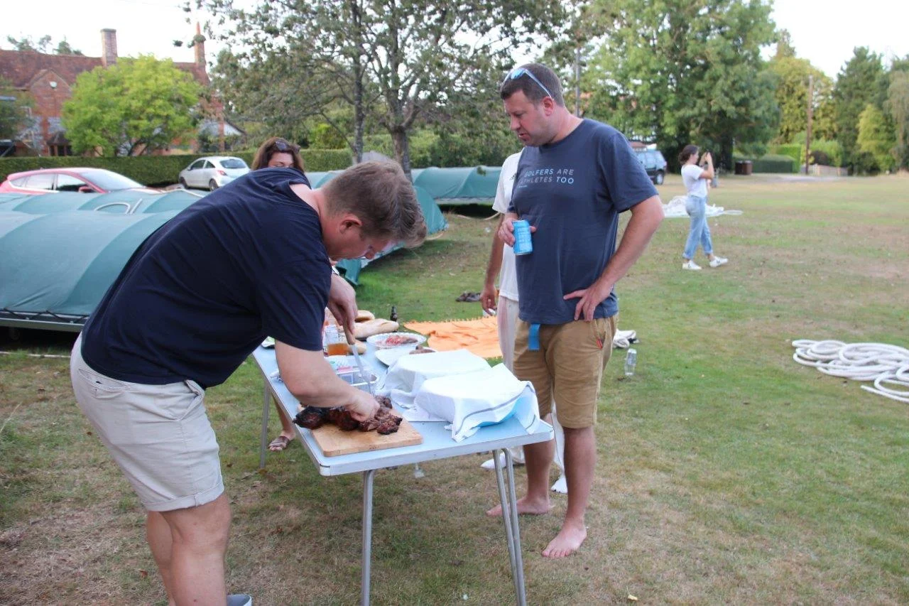 Chef Otto (fun is his motto and likes to get Blotto) carves the Butterfly Lamb whilst a Hungry Horse looks on