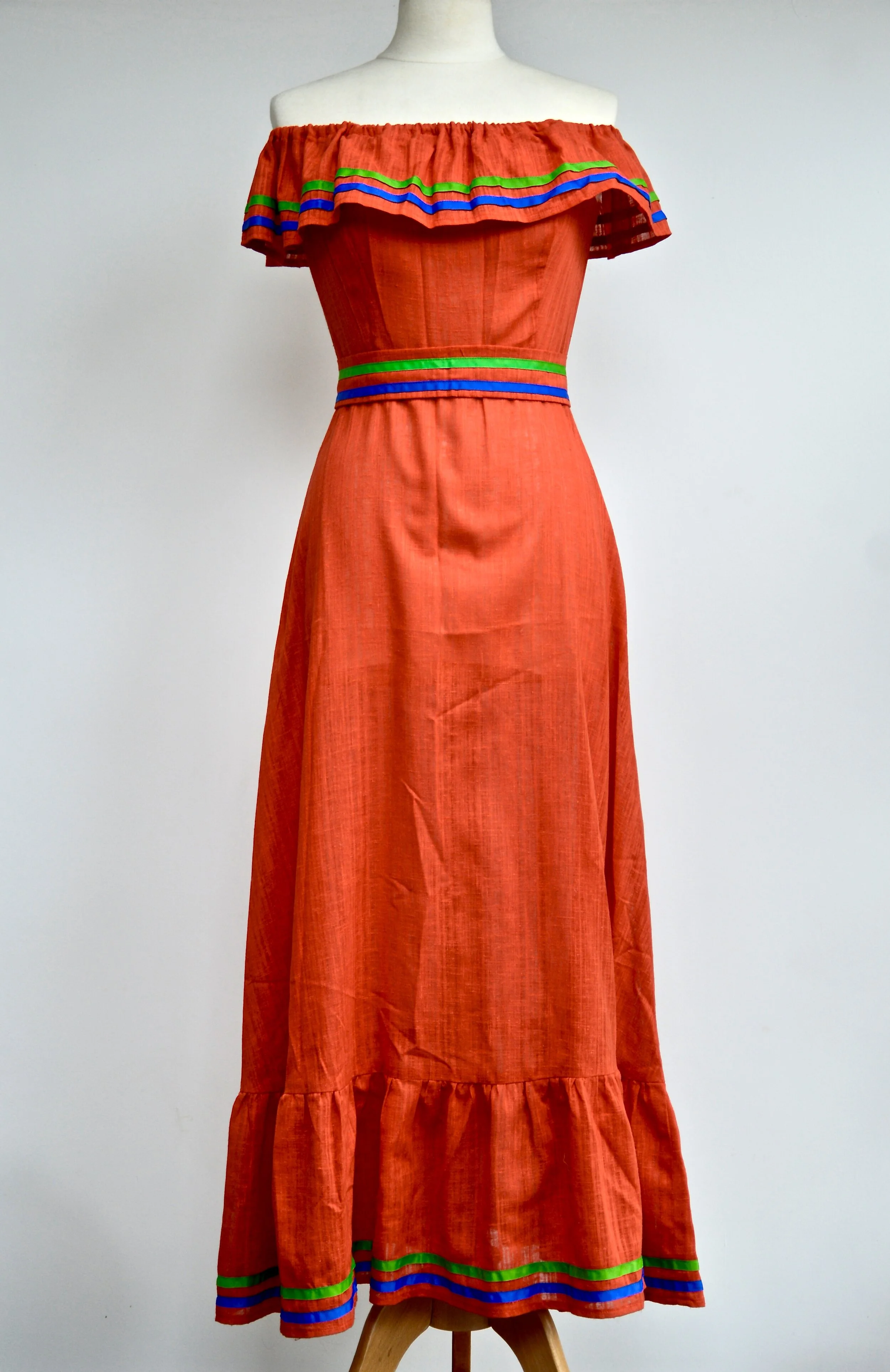 1970s Red off-the-shoulder maxi dress with green and blue ribbon detail.  Small. Scotland. —