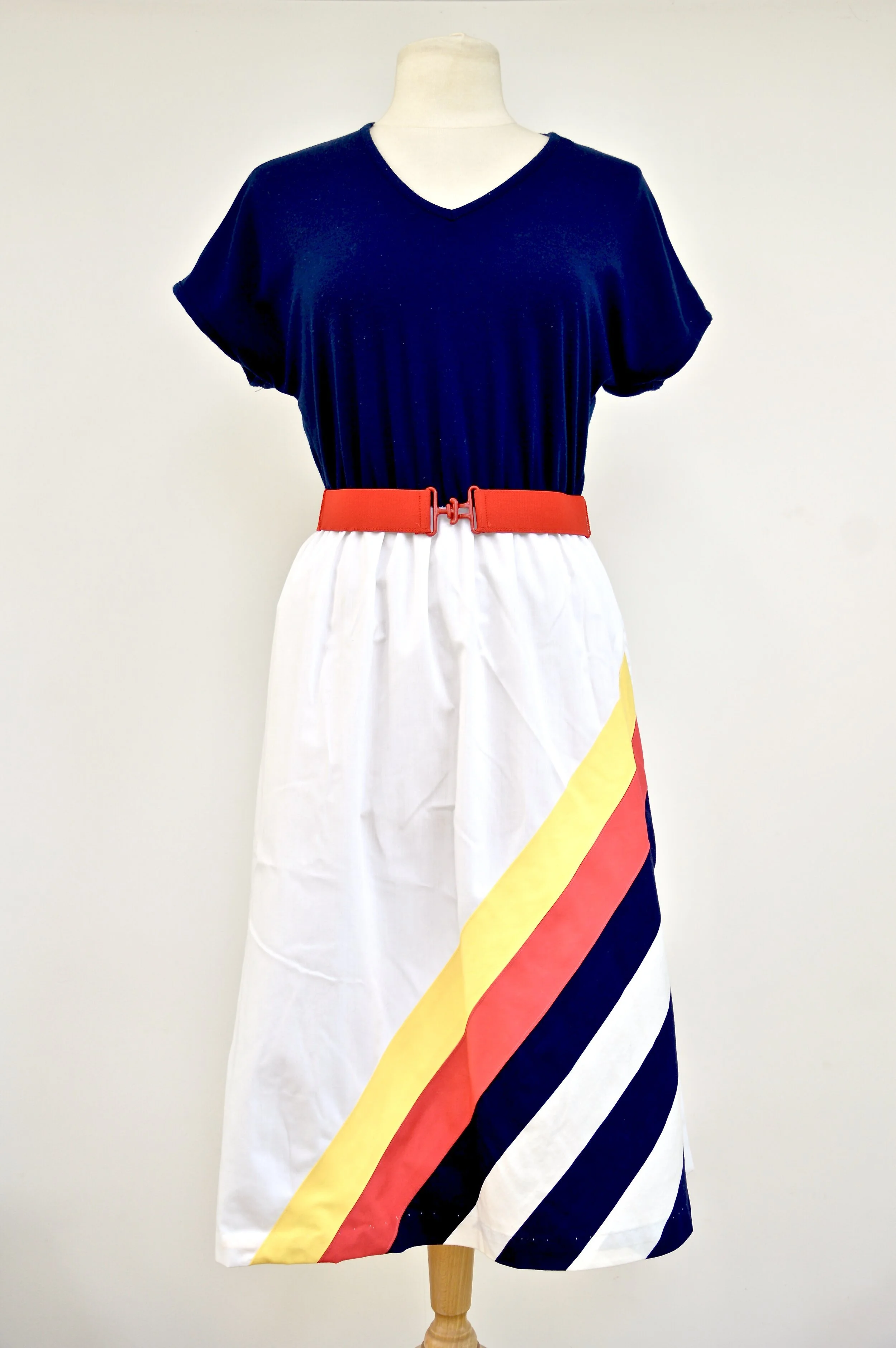 1970s Toni Todd dress with striped red, white yellow, blue skirt and original belt. Union made in the USA. Small-Medium.