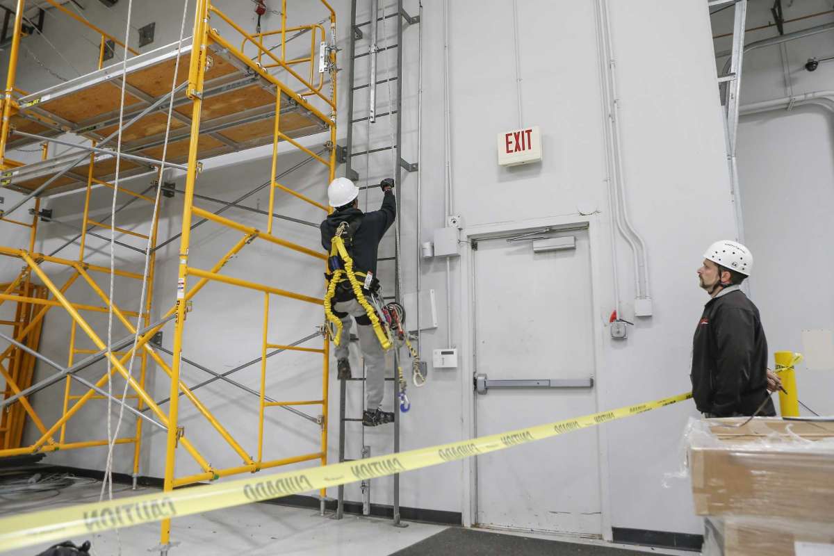 MIAT College of Technology Wind Turbine Instructor David Moriconi (right) watches a student performs a ladder exercise Wednesday, Oct. 24, 2018, in Houston. MIAT College of Technology has a seven-month wind power technician career training program.