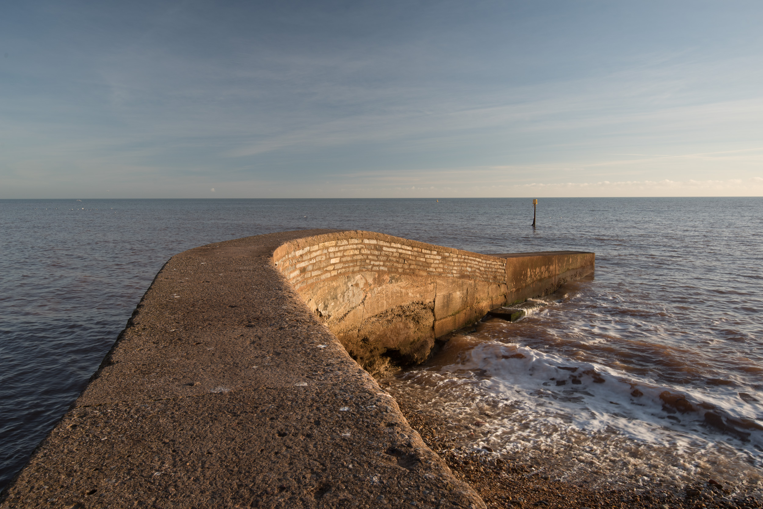 The addition of the polariser reduces the reflections on the groyne and brings out a little more detail in the sky. (Image unprocessed).