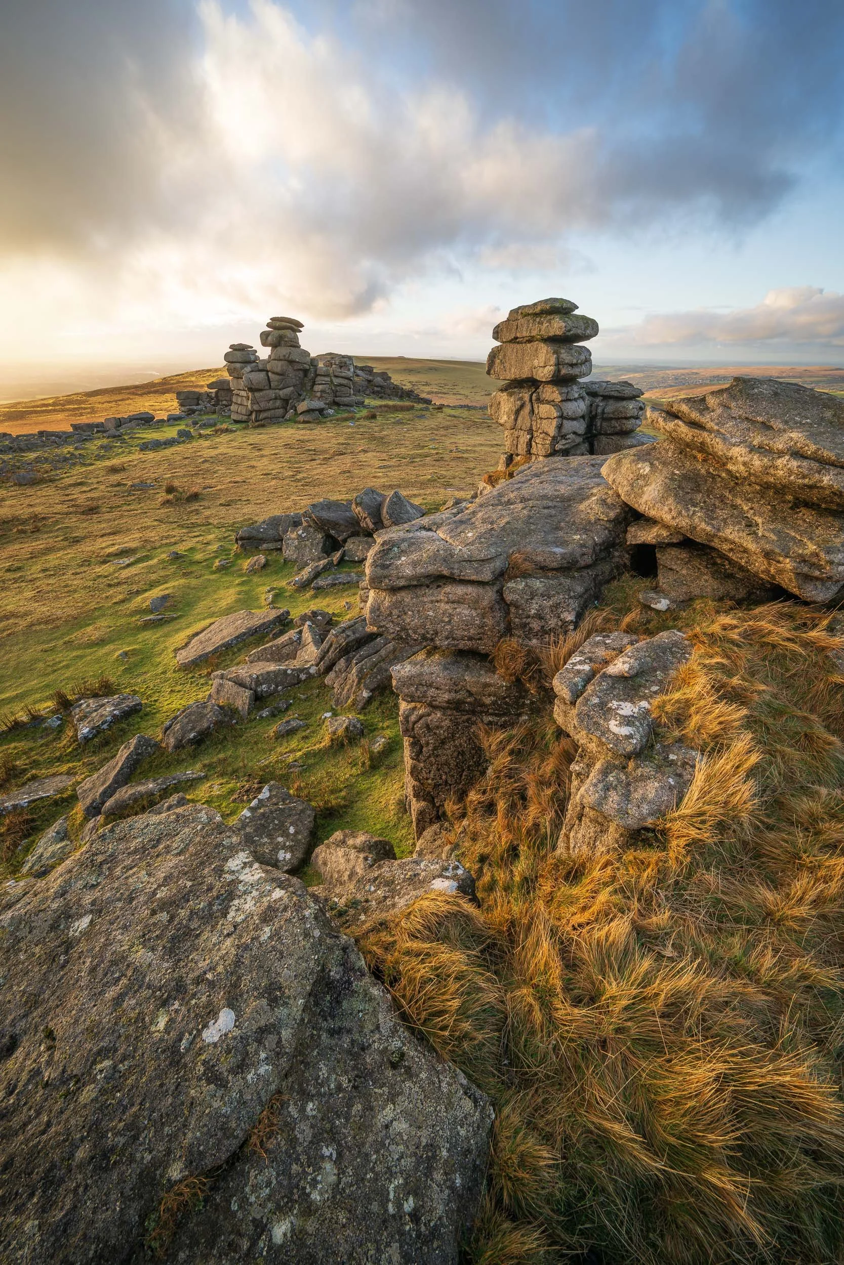 A sunset landscape photograph of Great Staple Tor on Dartmoor National Park