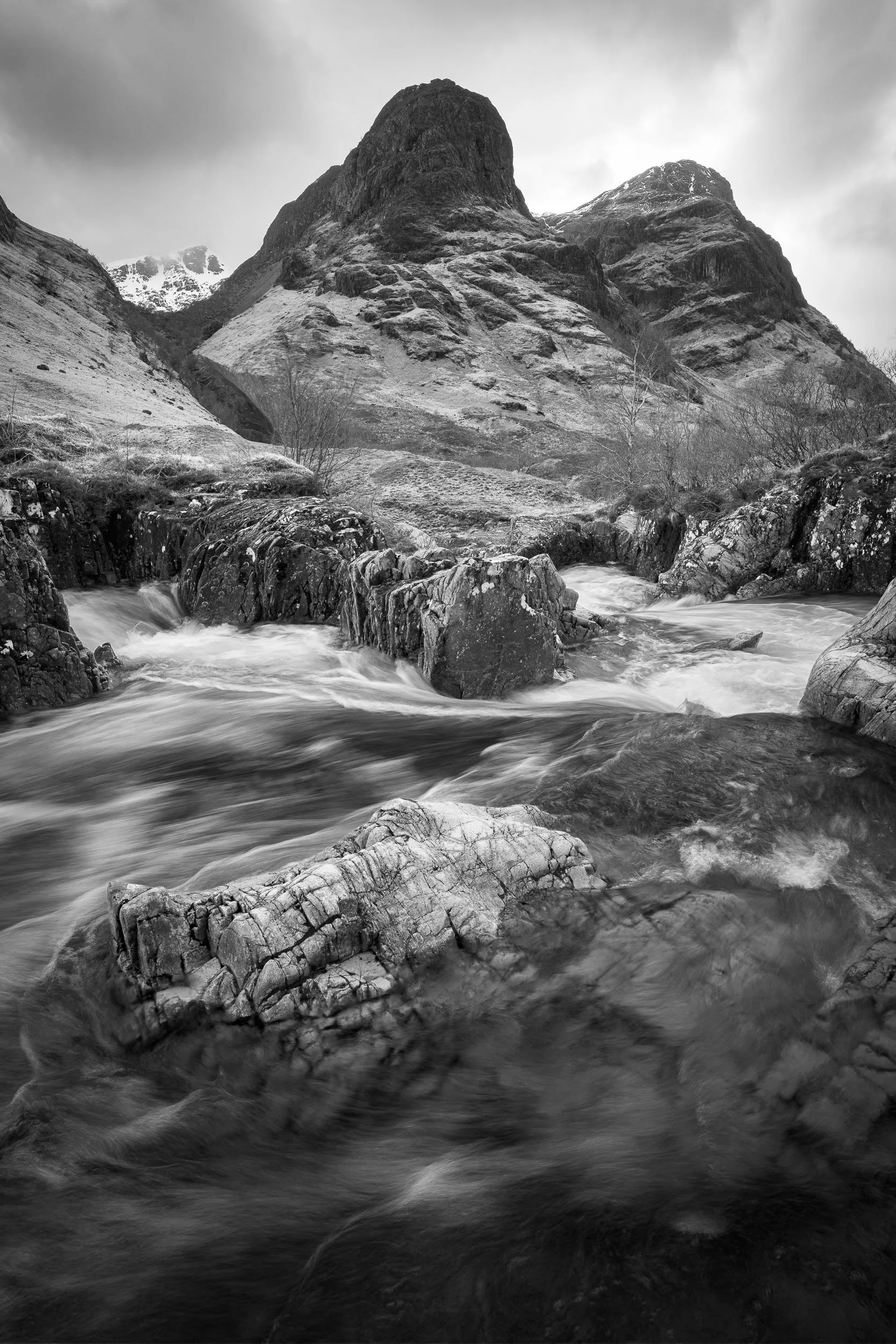 A high contrast black and white photograph of a waterfall on the River Coe in Glen Coe