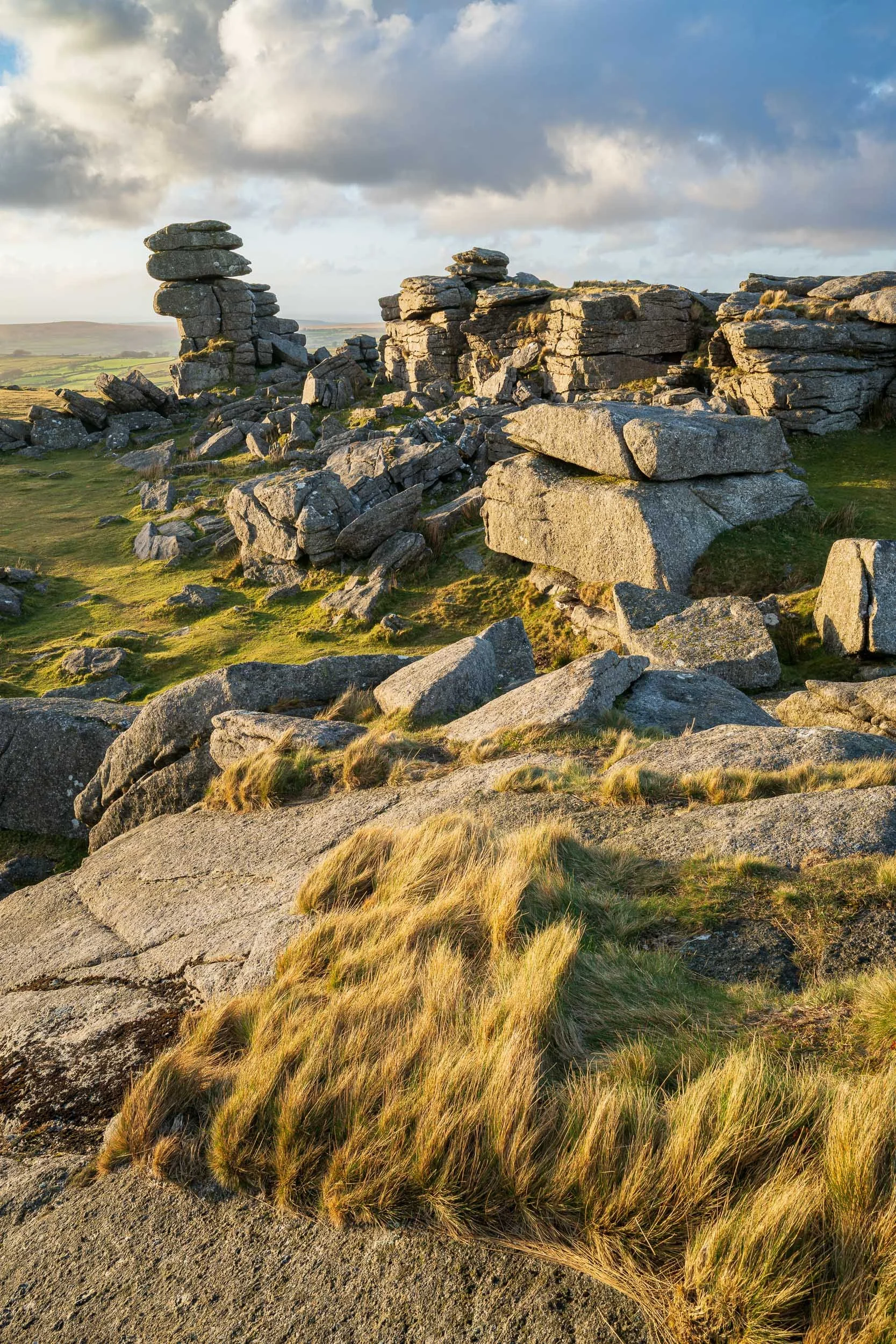 A landscape photograph of Great Staple Tor on Dartmoor taken at sunset.