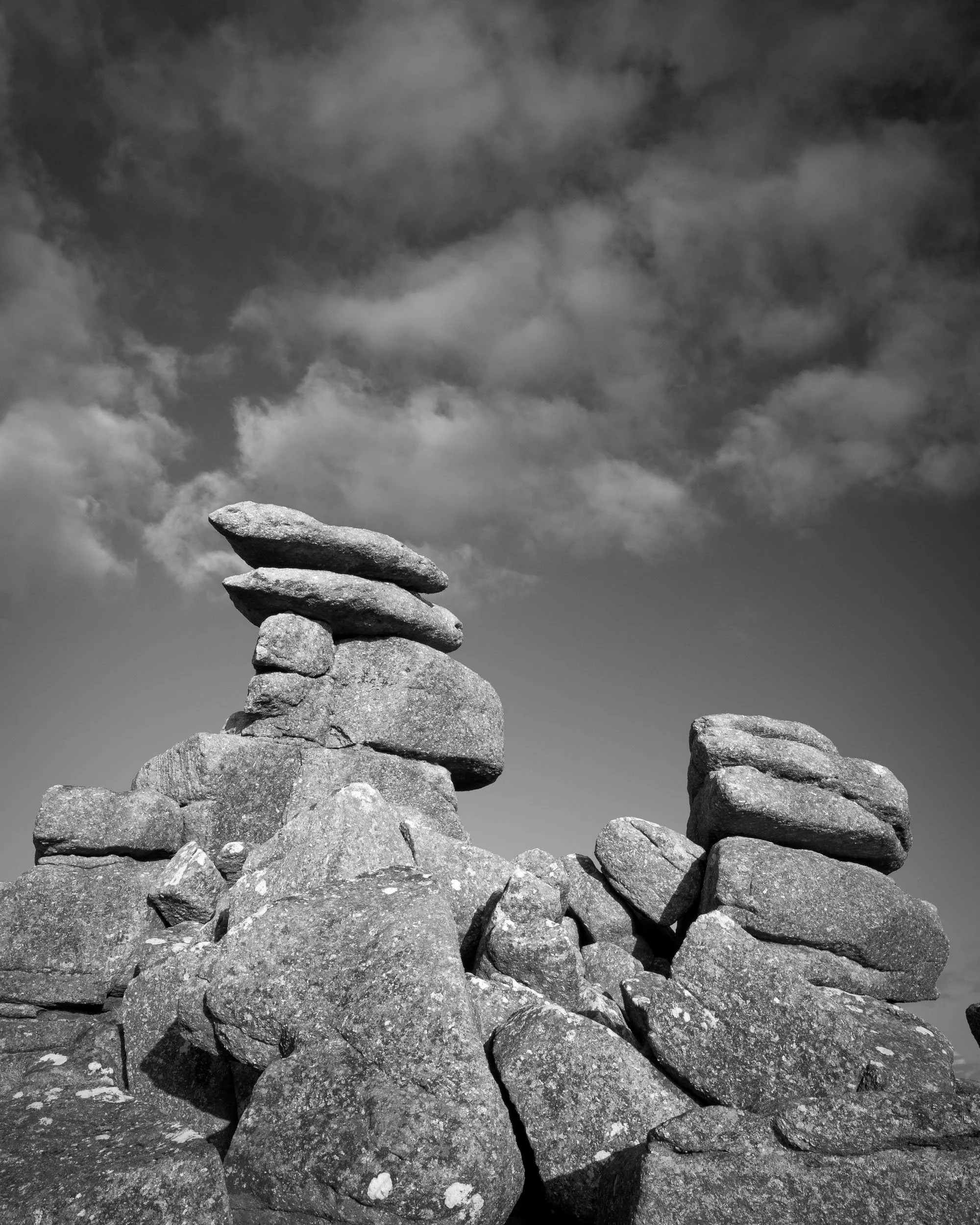A black and white photograph of Great Staple Tor on Dartmoor National Park