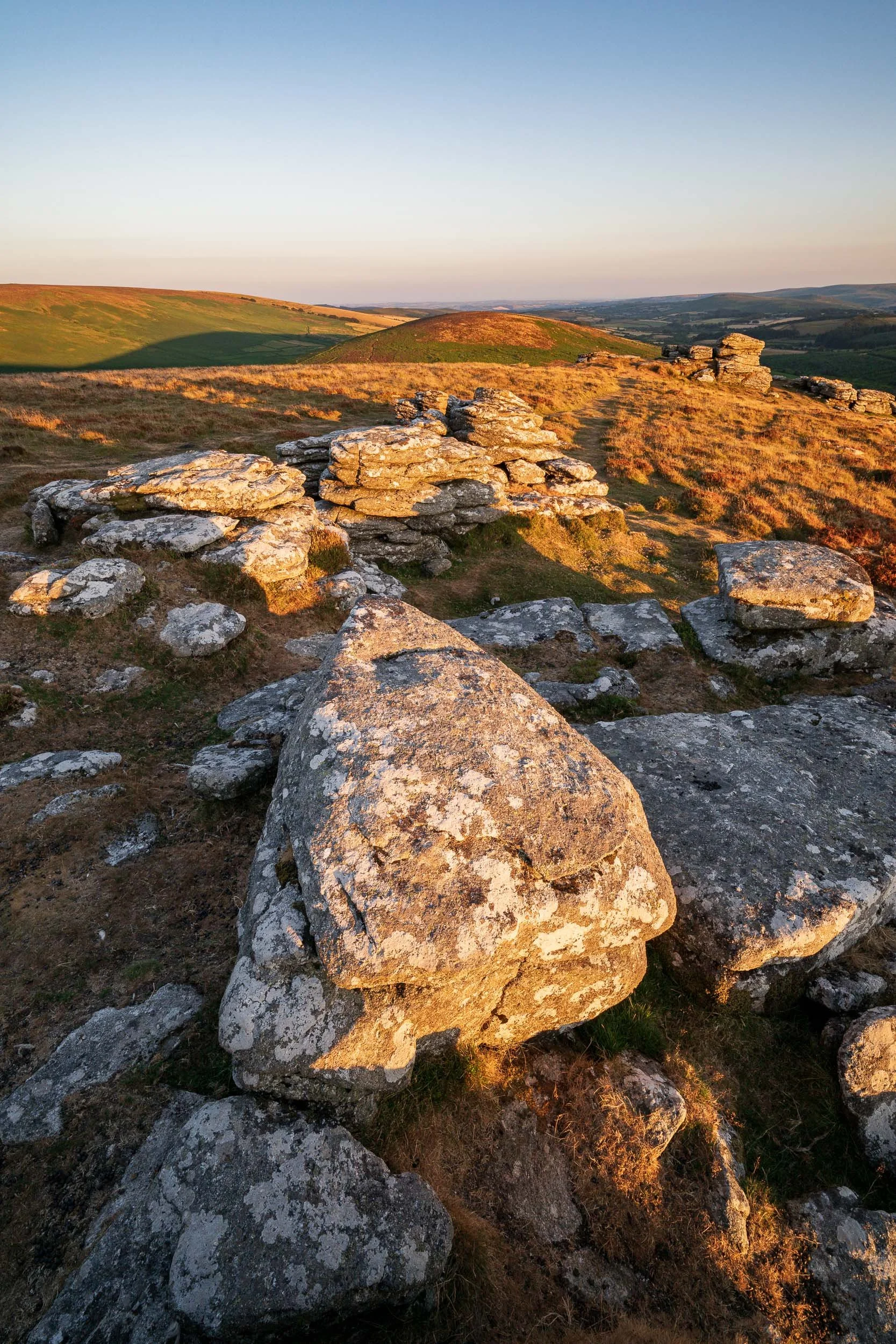 A sunset landscape photograph of Birch Tor on Dartmoor National Park