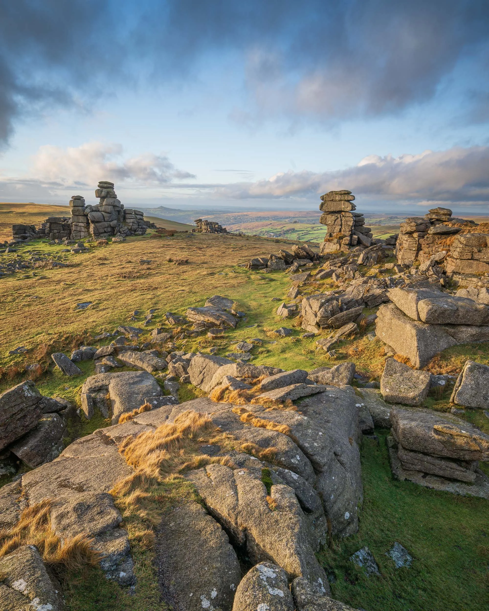 A landscape photograph of Great Staple Tor on Dartmoor taken at sunset.