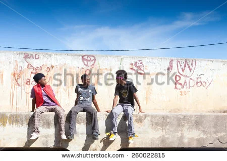 stock-photo-cape-town-south-africa-january-three-young-township-men-sit-and-talk-on-a-bridge-with-filthy-260022815.jpg
