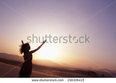 stock-photo-serene-young-woman-with-arms-outstretched-doing-yoga-in-the-desert-158326415.jpg
