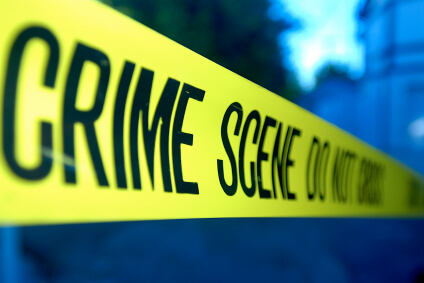 Yellow crime scene tape that says "Crime scene do not cross".
