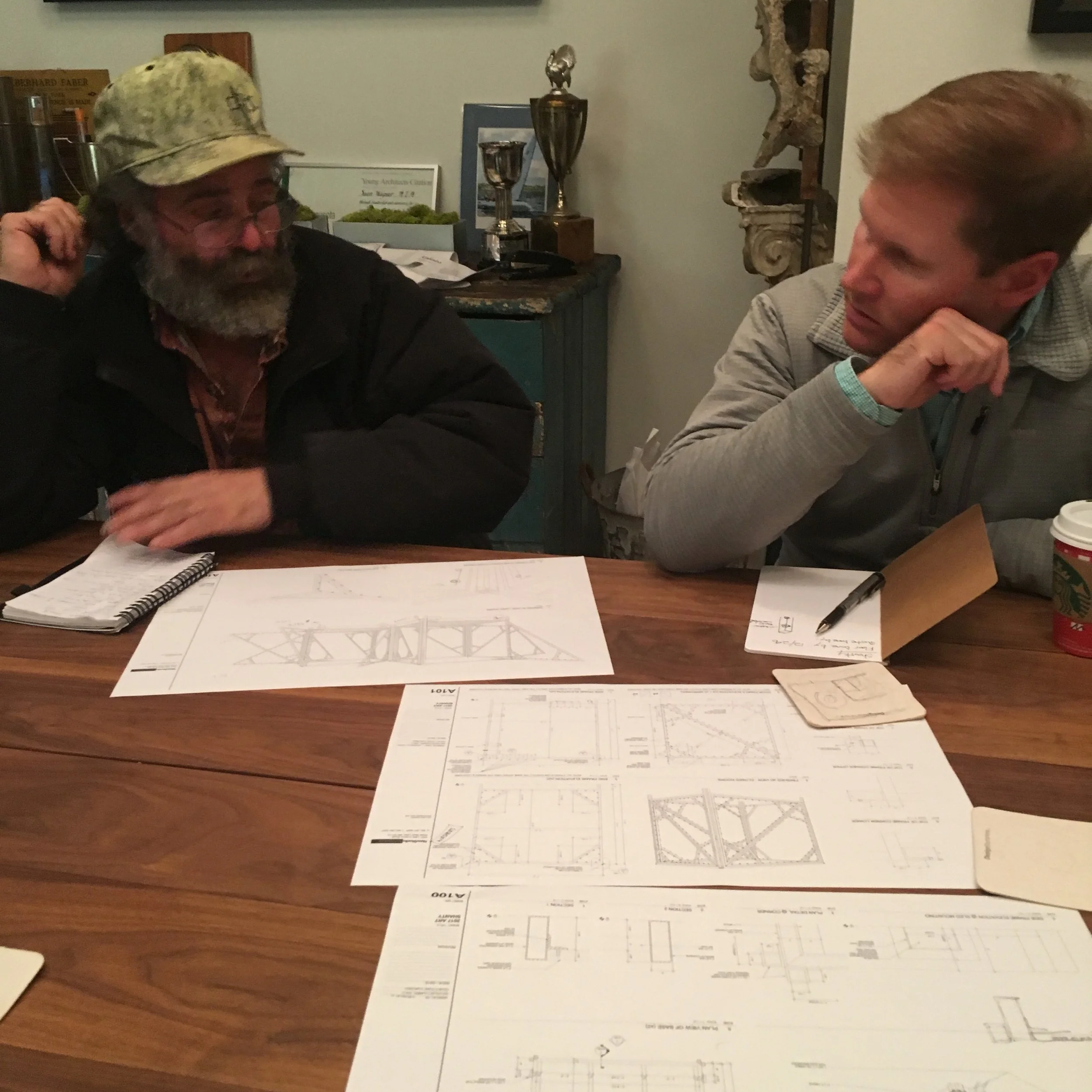 Kevin "The Welder" and Mark look over plans for the frame.