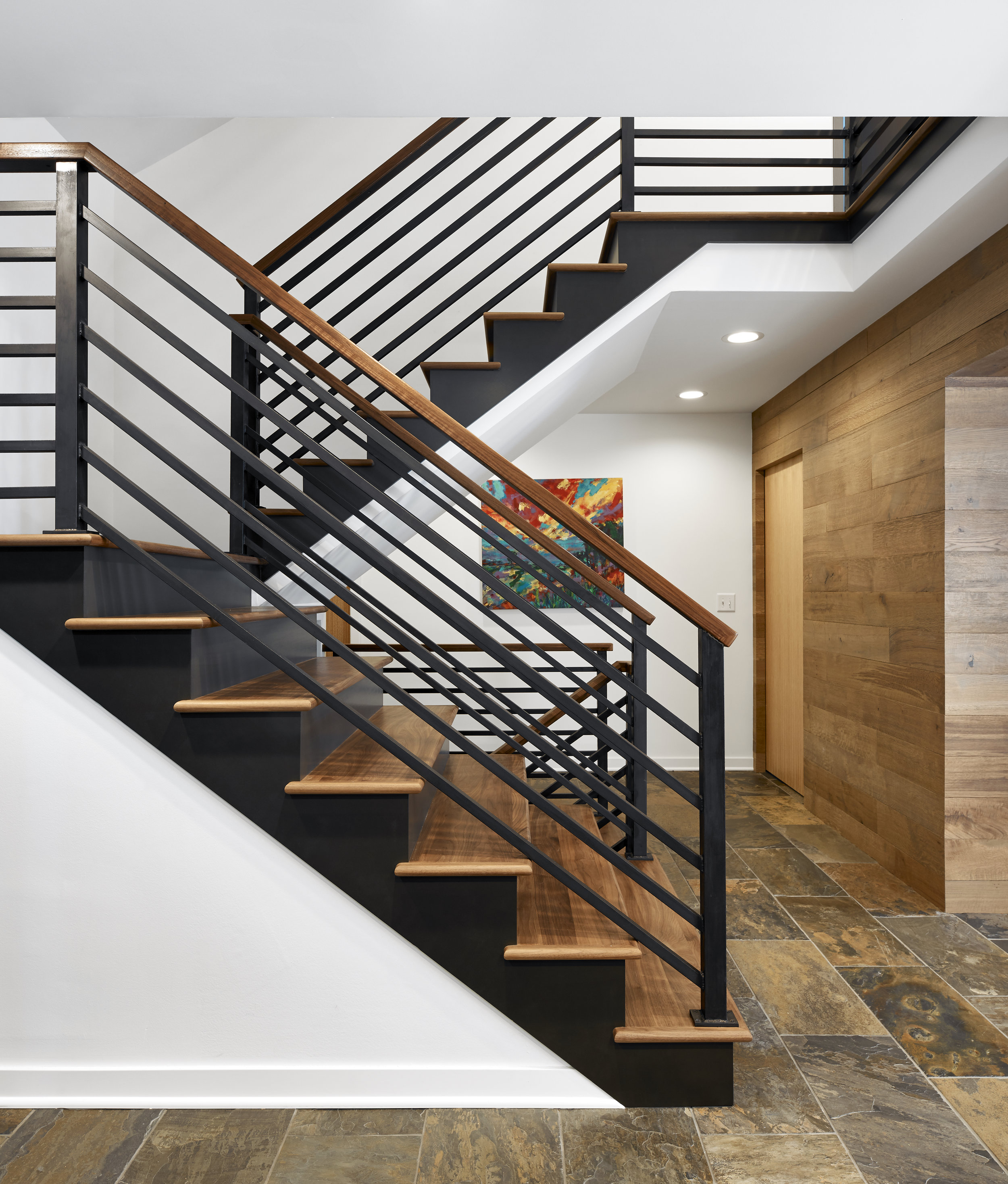Dramatic steel and wood staircase, designed by NewStudio Architecture