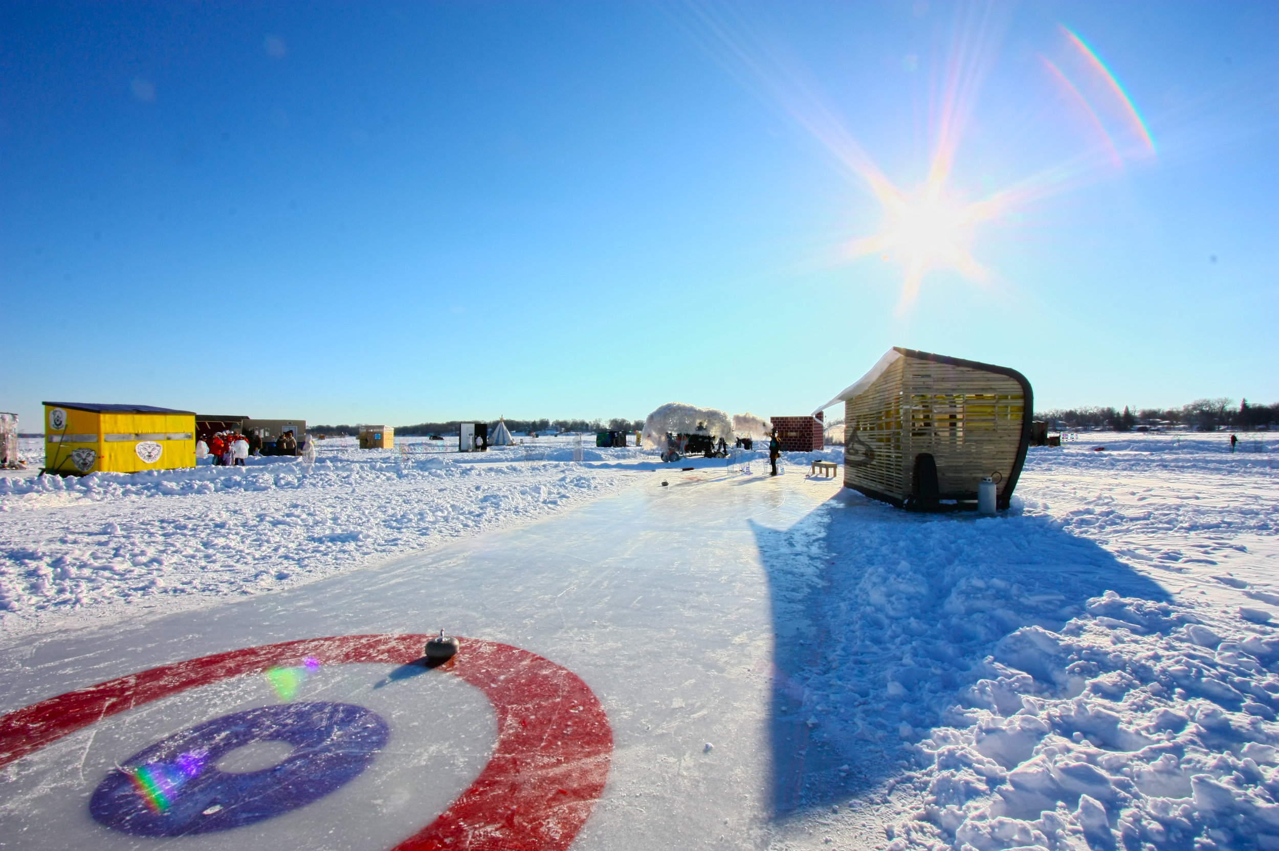 NewStudio Architecture's art shanty among other entries on a bright winter's day 