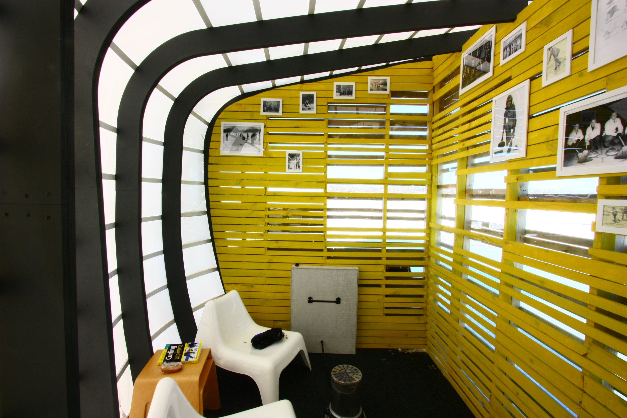 Warm interior of curling-themed art shanty designed by NewStudio Architecture