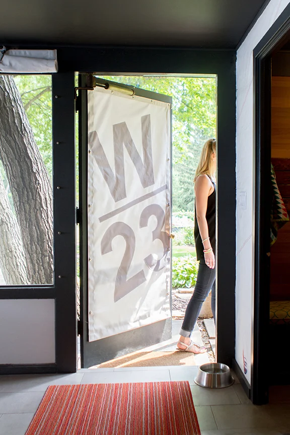 Repurposed sail on door of mid-century modern boathouse, designed by NewStudio Architecture