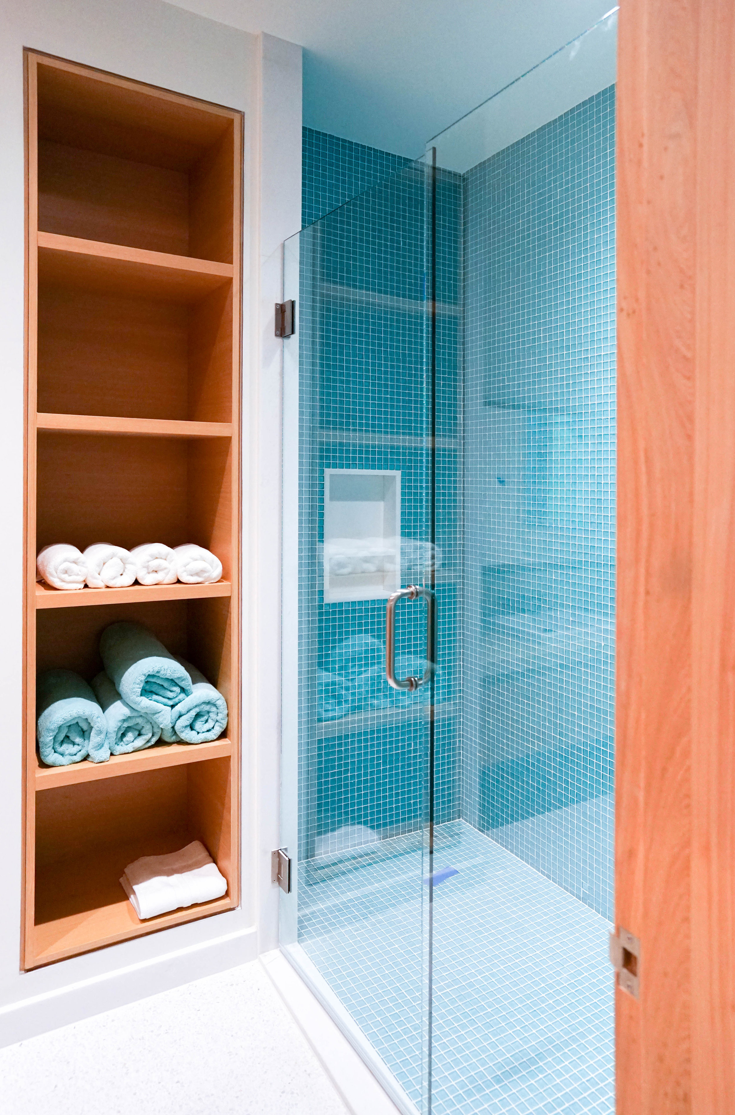 Aqua tile shower designed by NewStudio Architecture