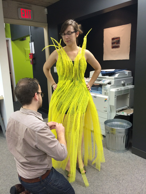 NewStudio Architecture staff members create a polymer-mat dress for the IIDA Fusion + Fashion fundraiser