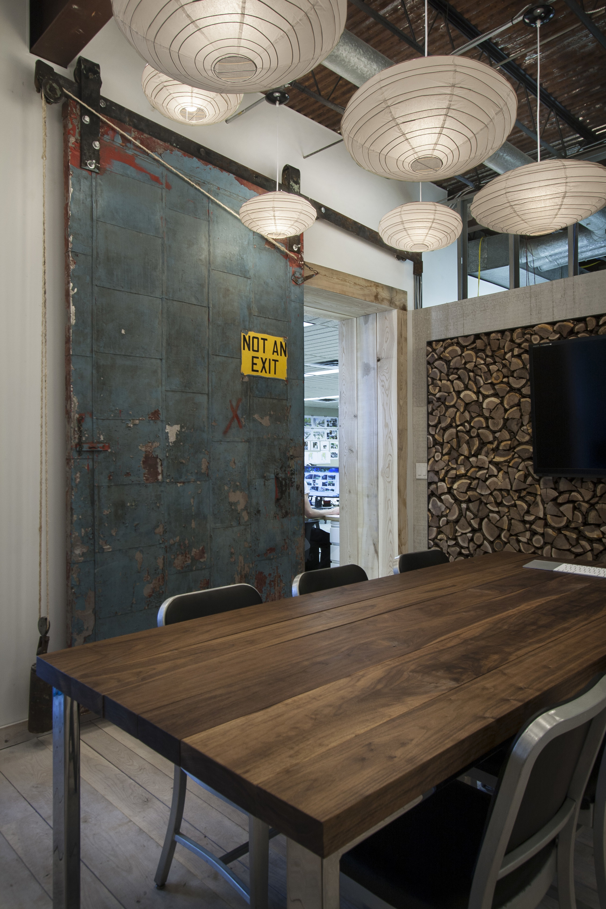 Meeting space with reclaimed door at NewStudio Architecture's original office