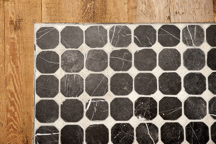 Close-up of wood planks with tile inset 