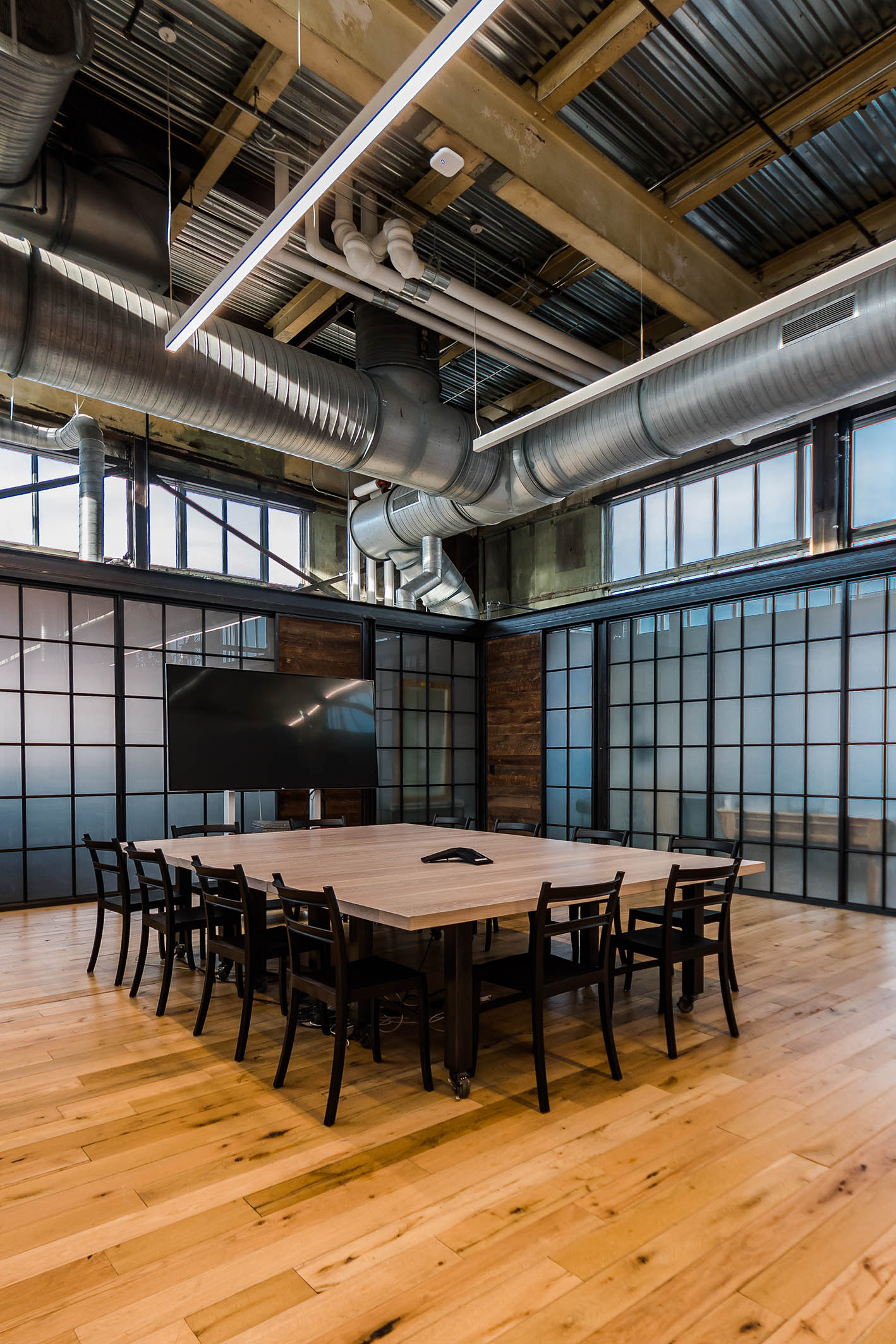 NewStudio Architecture collaborated with URBN to design the Terrain meeting area in the adaptive reuse of the Navy Yard Building 18 Annex