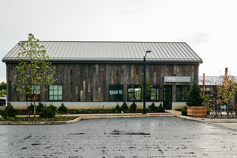 Reclaimed barn wood exterior reflects the sophisticated rustic ambiance of Amis Trattoria at Devon Yard 