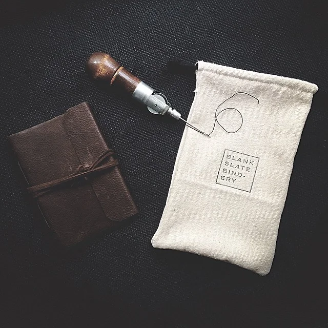 Sparing no expense for packaging the journals with custom hand stamped linen drawstring bags. This also means learning how to sew. (Thanks mom!)