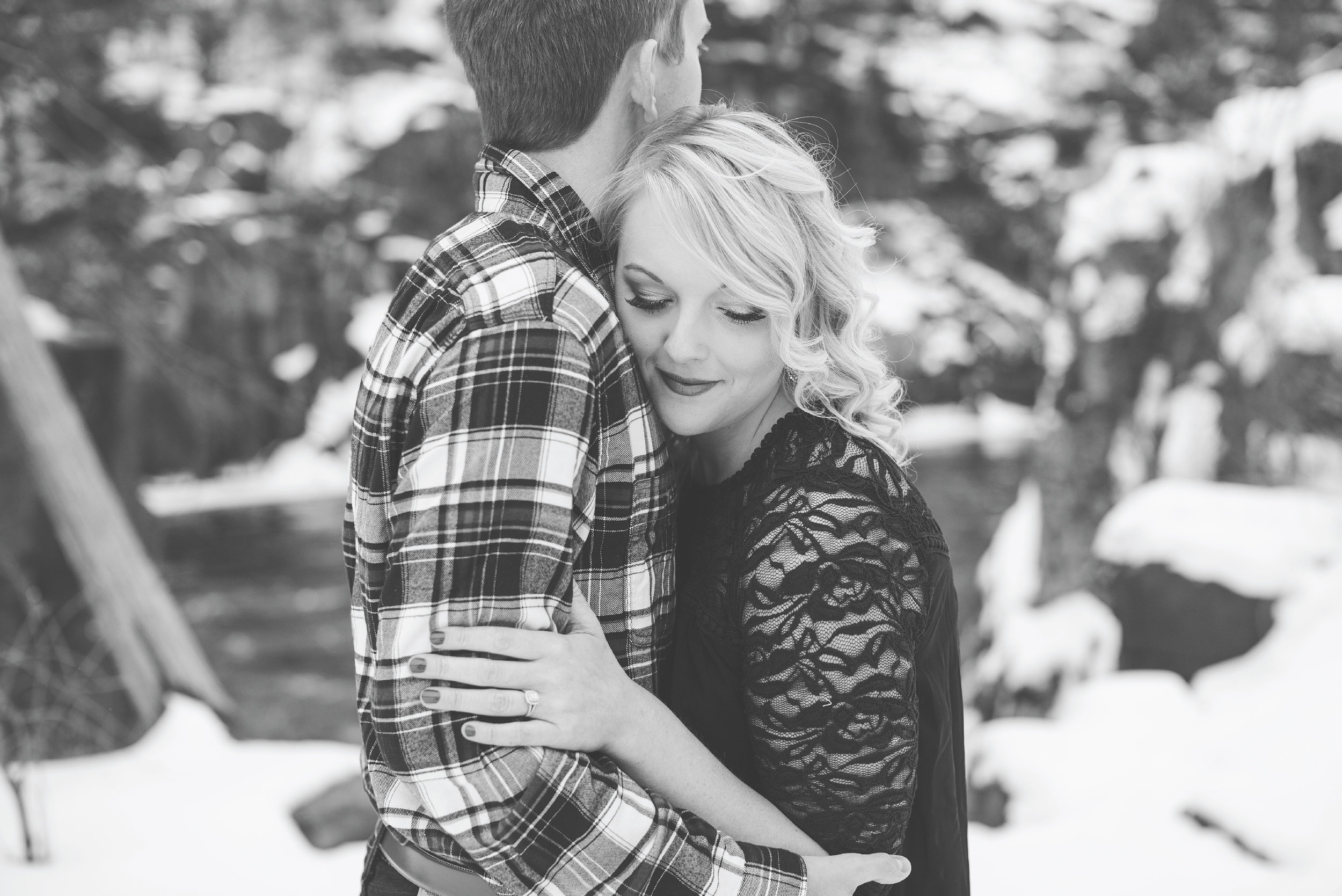Minnesota snowy winter engagement photos in Taylors Falls Minnesota hugging in black and white