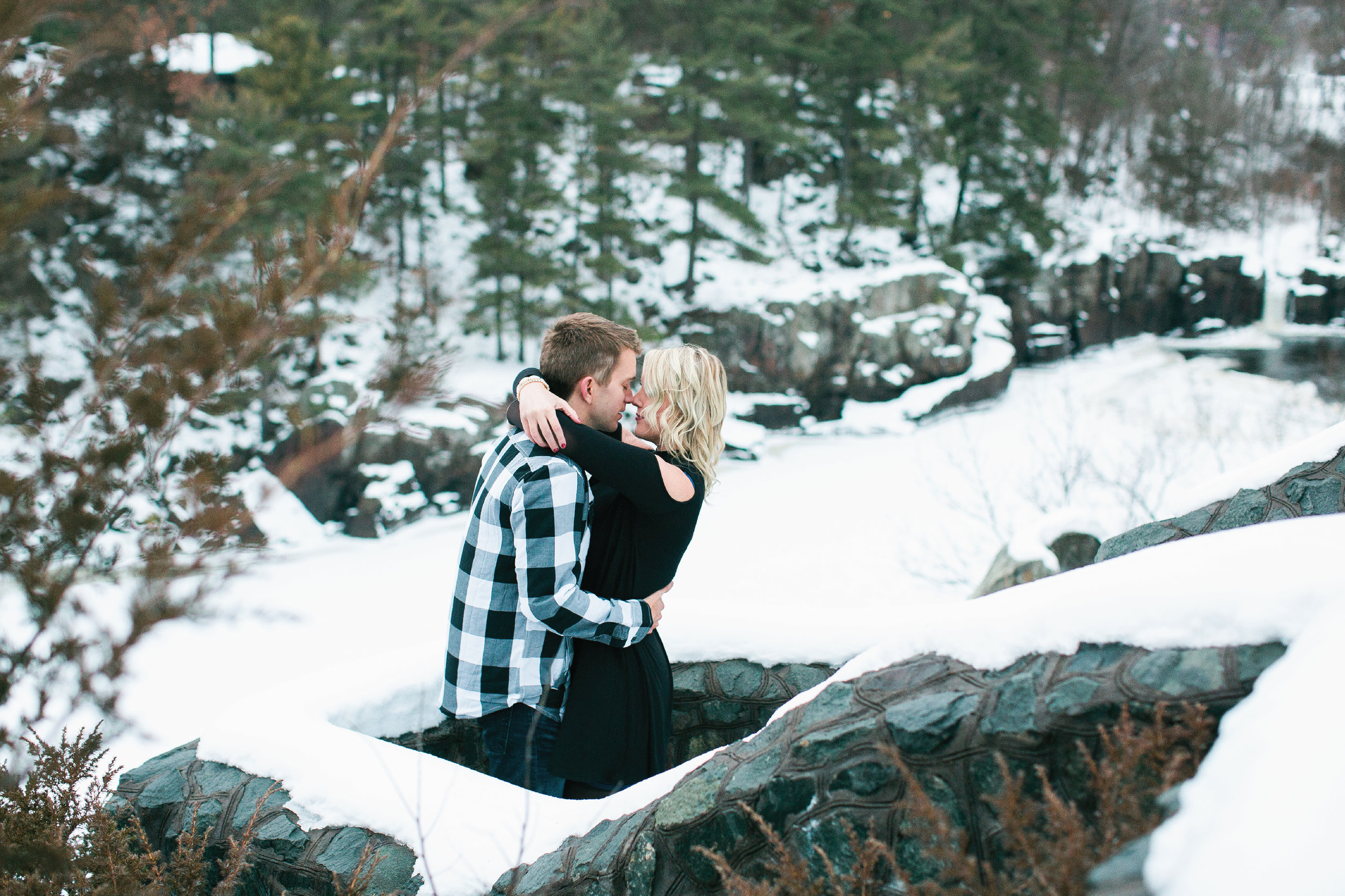 Snowy Minnesota Taylors Falls winter engagement photos on bluff overlooking river and woods