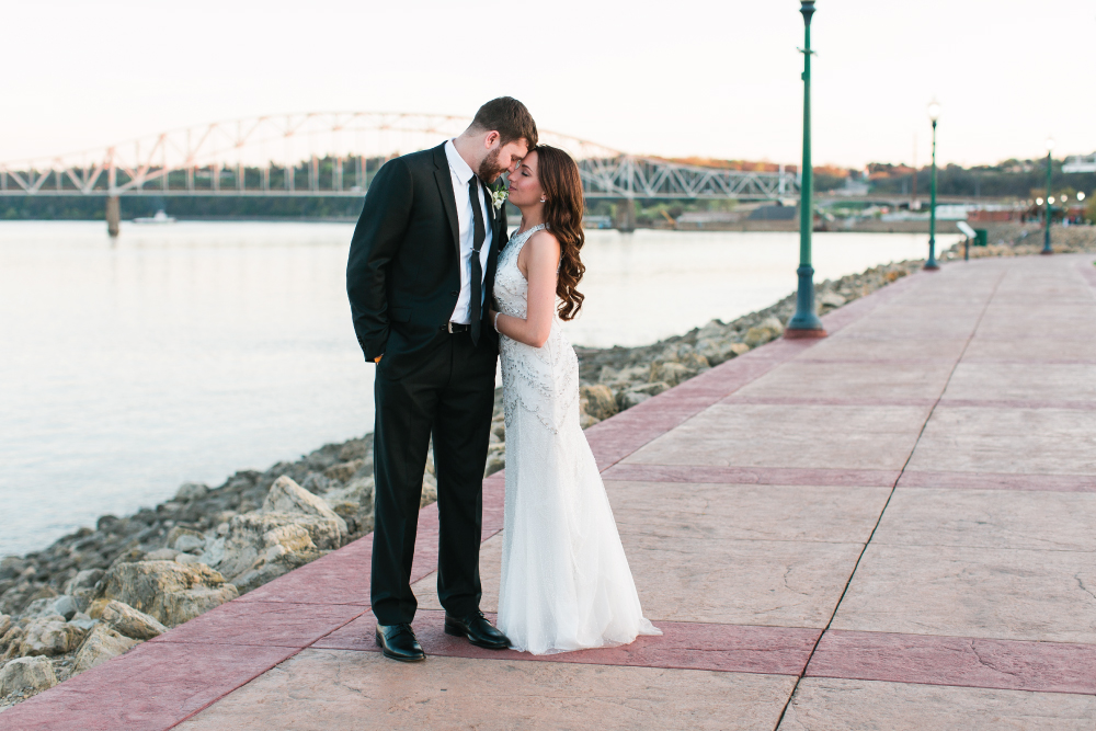 Dubuque IA River Center Wedding, modern beaded wedding gown and black suit. Photographed by Mallory Kiesow.