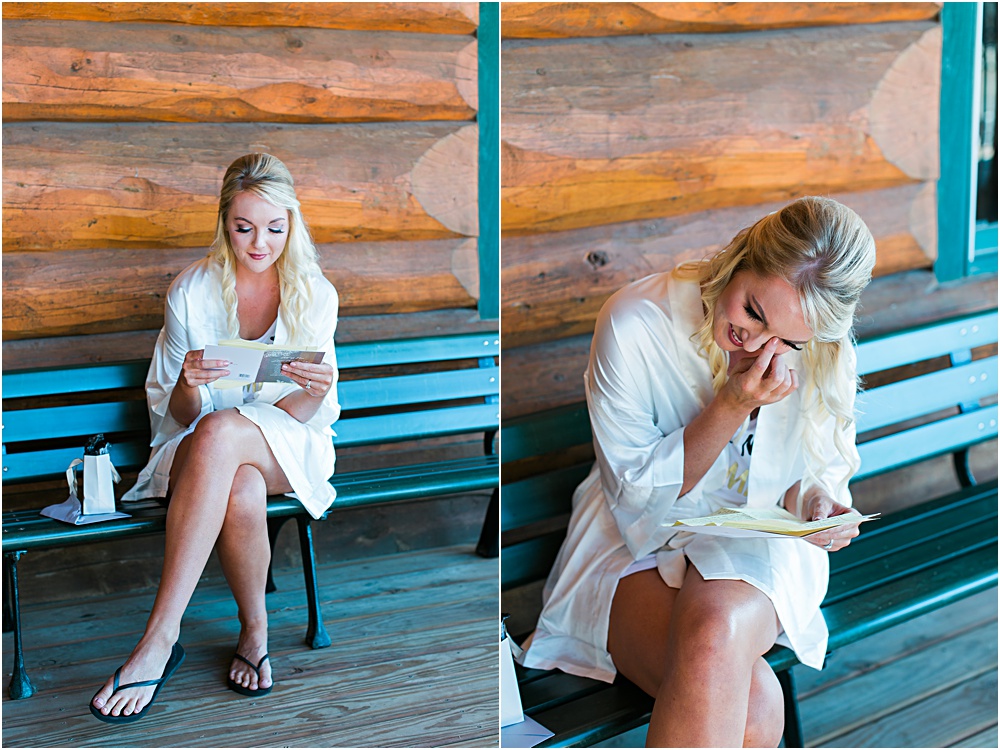 Minnesota summer wedding bride reading card and opening gift from groom in heartfelt moment