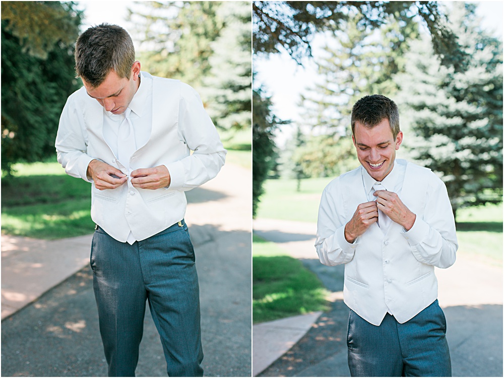 Groom getting ready for Minnesota summer wedding day in dark gray suit and white vest