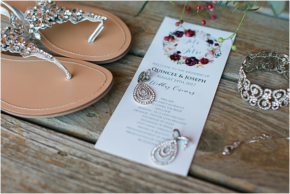 Minnesota summer wedding photo showing invitation, jewelry and shoes