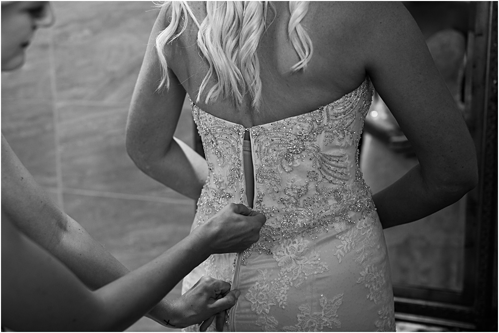 Bride getting ready for Minnesota summer wedding day in black and white detail of back of dress