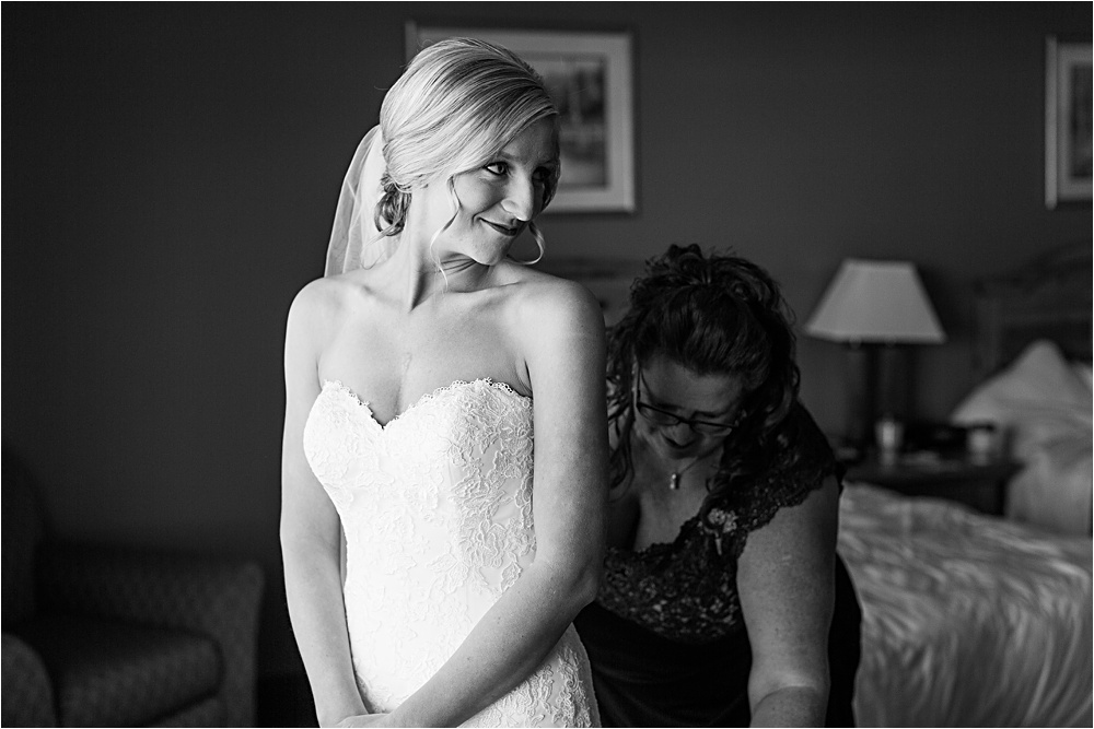 Bride getting ready with mom in black and white photo at Minnesota summer wedding