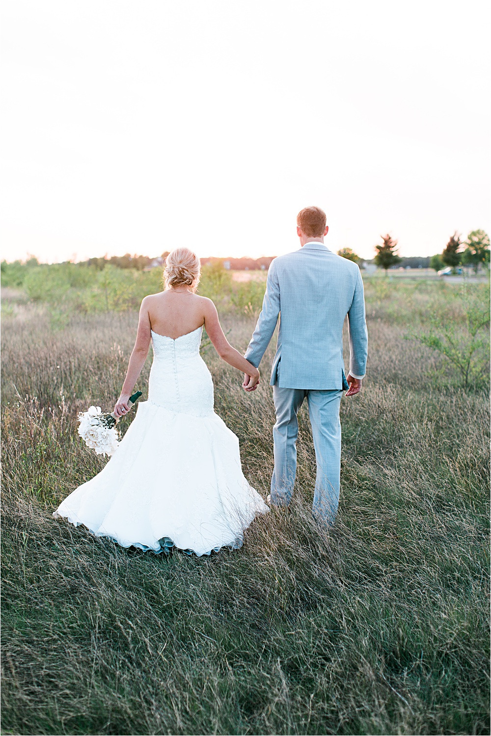 Bride and groom sunset portrait outside in field at Minnesota summer wedding in Buffalo MN photographed by Mallory Kiesow, Minnesota wedding photographer