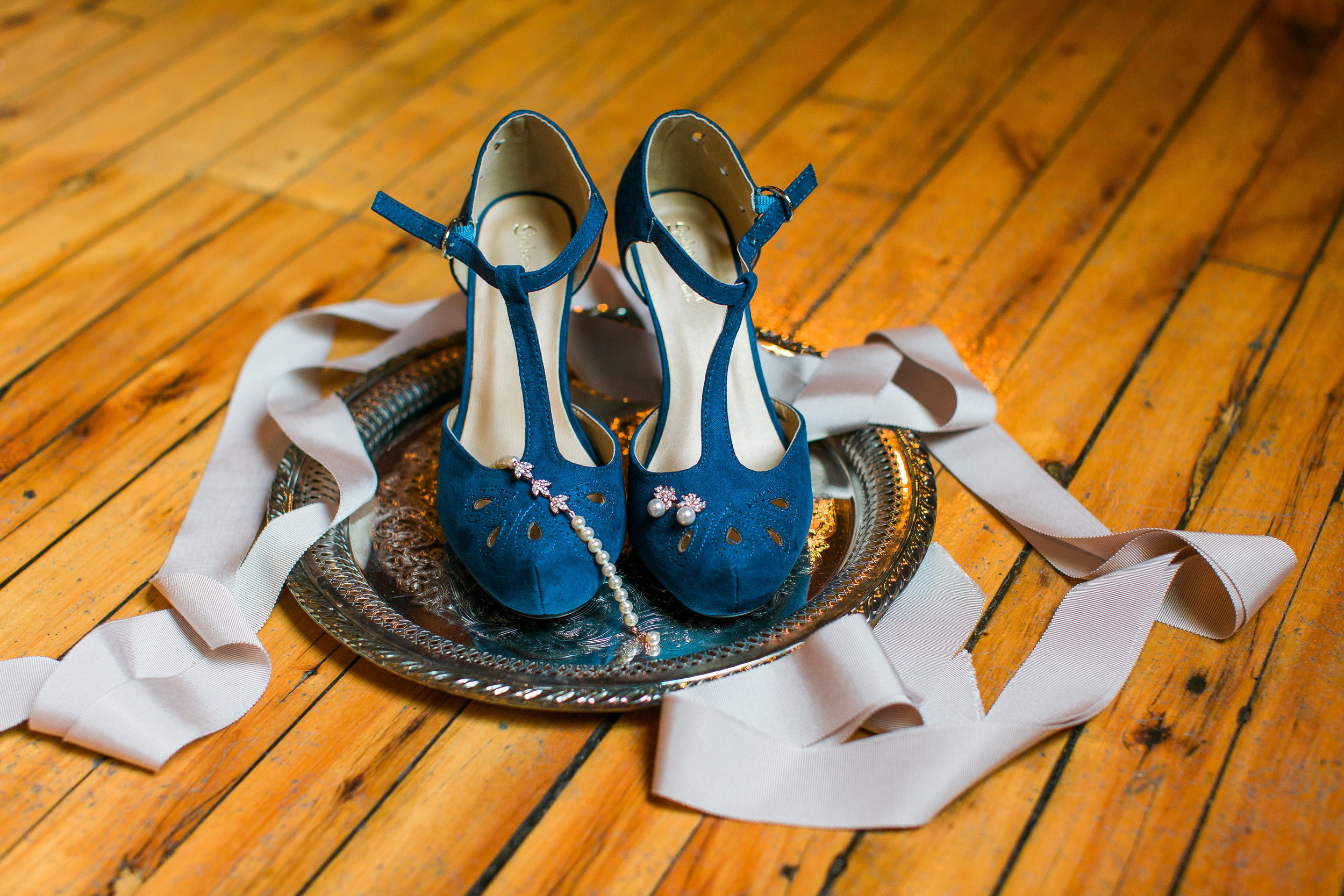 Minneapolis Event Centers wedding details of blue bridal shoes and jewlery Minnesota wedding photography Mallory Kiesow Photography