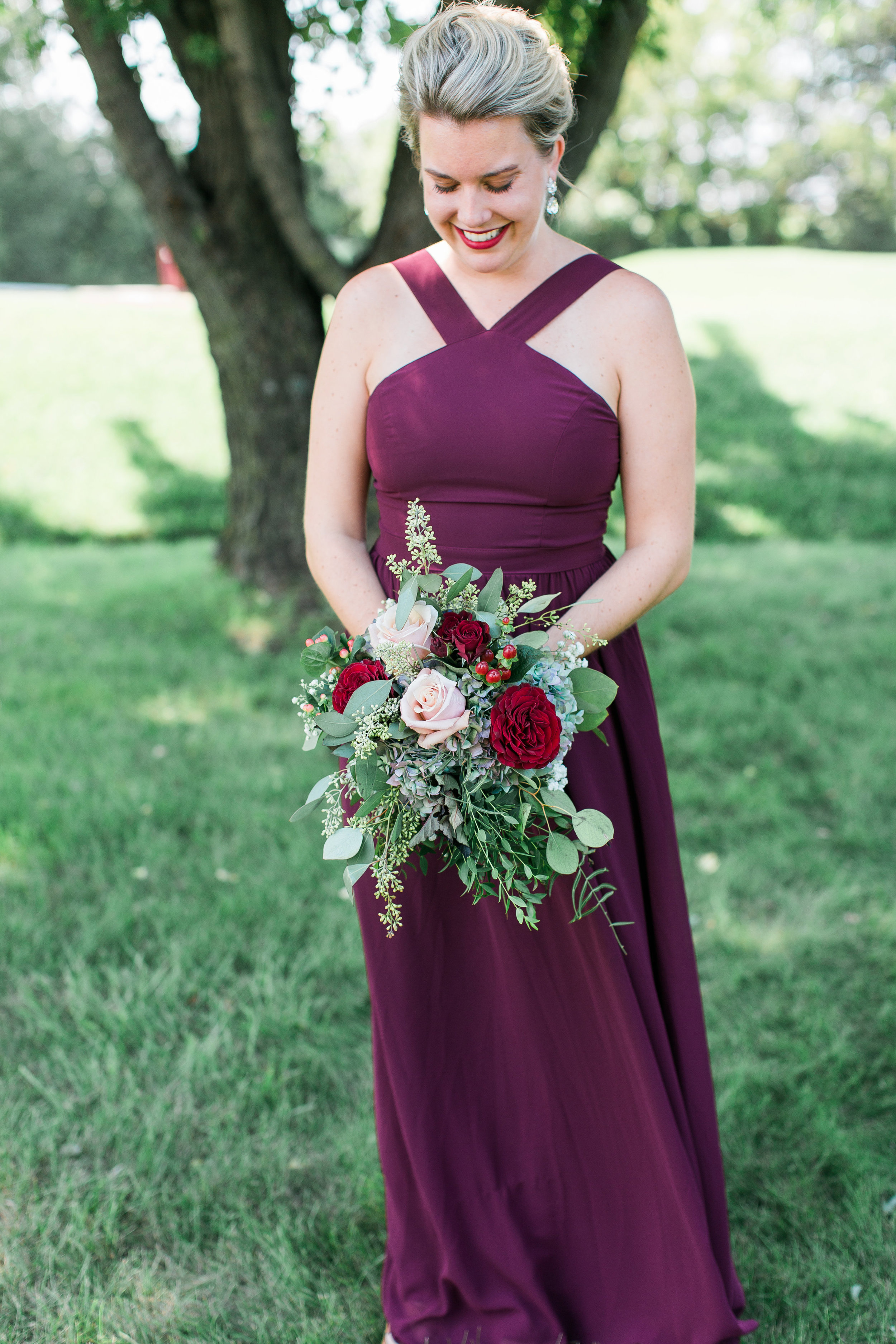 Minnesota bridesmaid in burgundy dress with stunning bouquet Minnesota wedding photography Mallory Kiesow Photography 