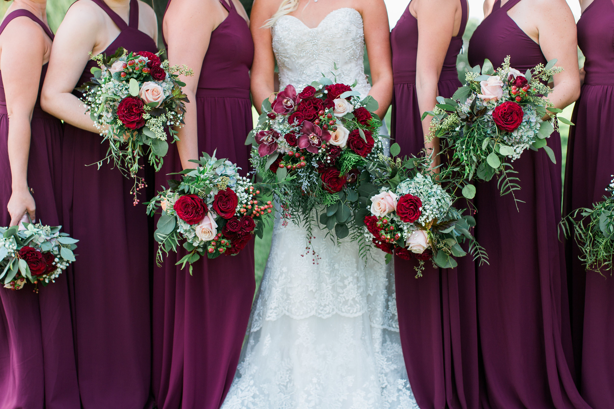 Minnesota bridesmaids in wine maroon burgundy dresses with bouquets Minnesota wedding photography Mallory Kiesow Photography