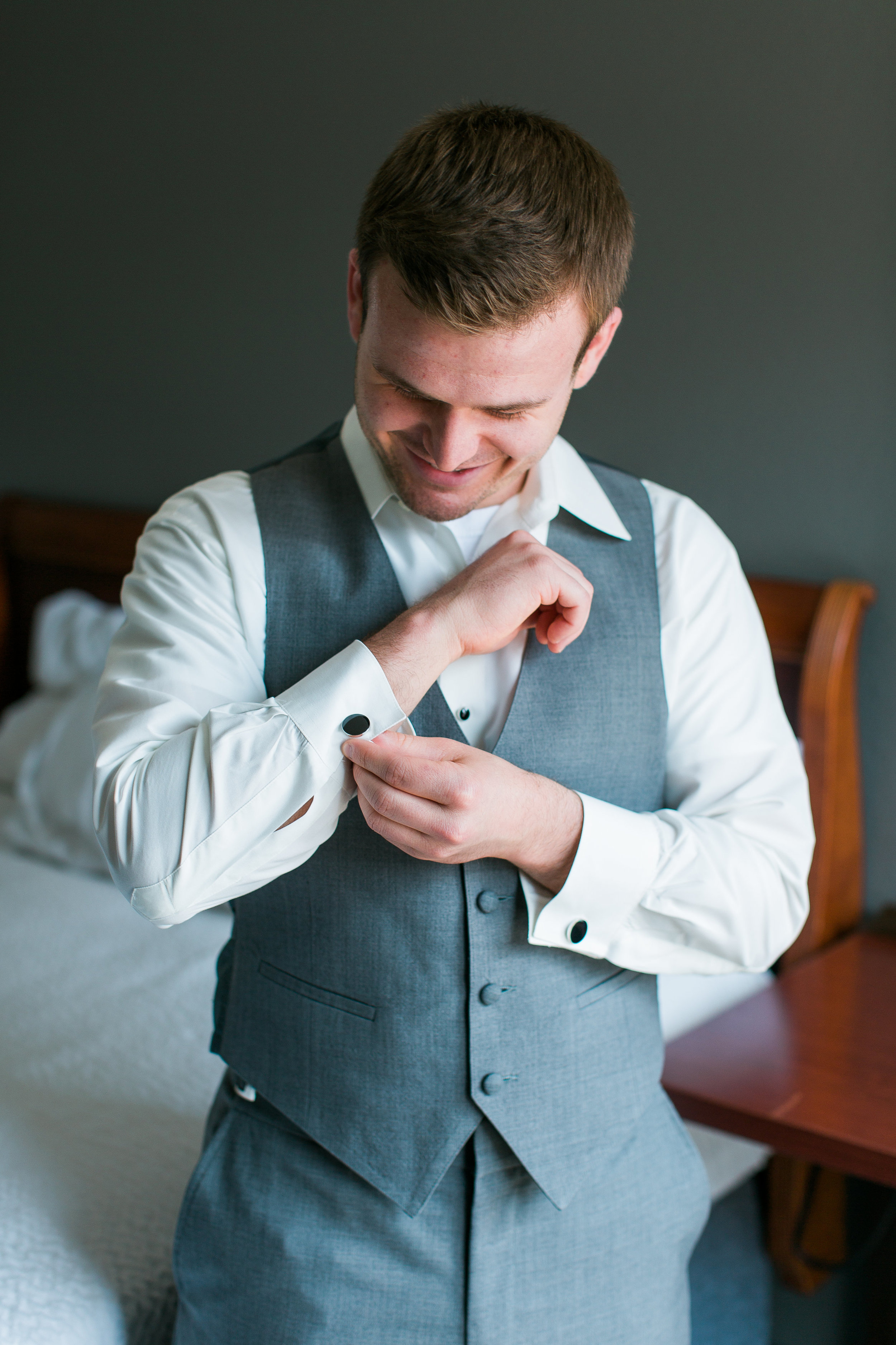 Minneapolis groom doing cufflinks getting ready for wedding Minnesota wedding photography Mallory Kiesow Photography