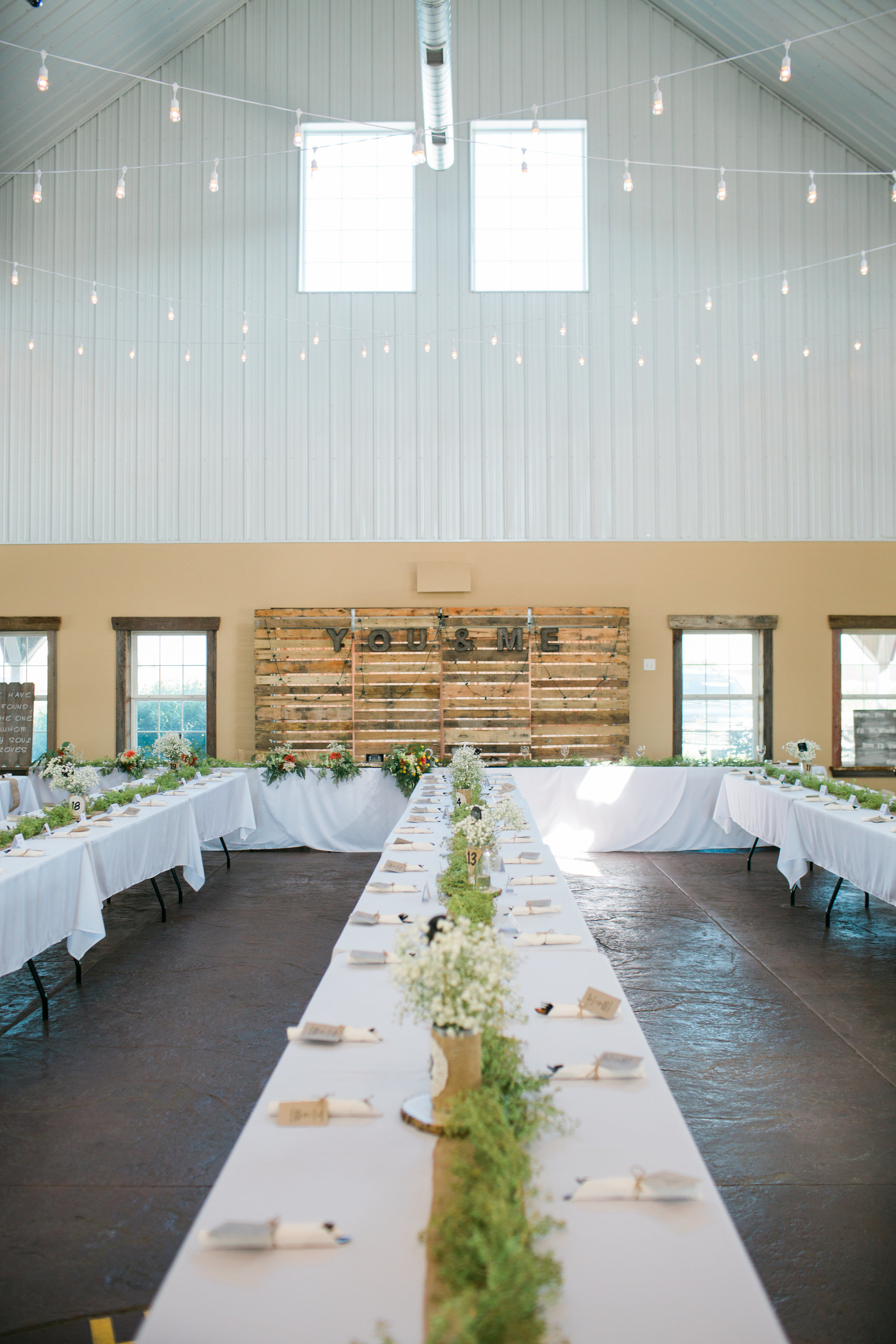 The Outpost Center in Chaska Minnesota reception space setup white cafe lights rustic Minnesota wedding photography Mallory Kiesow Photography 