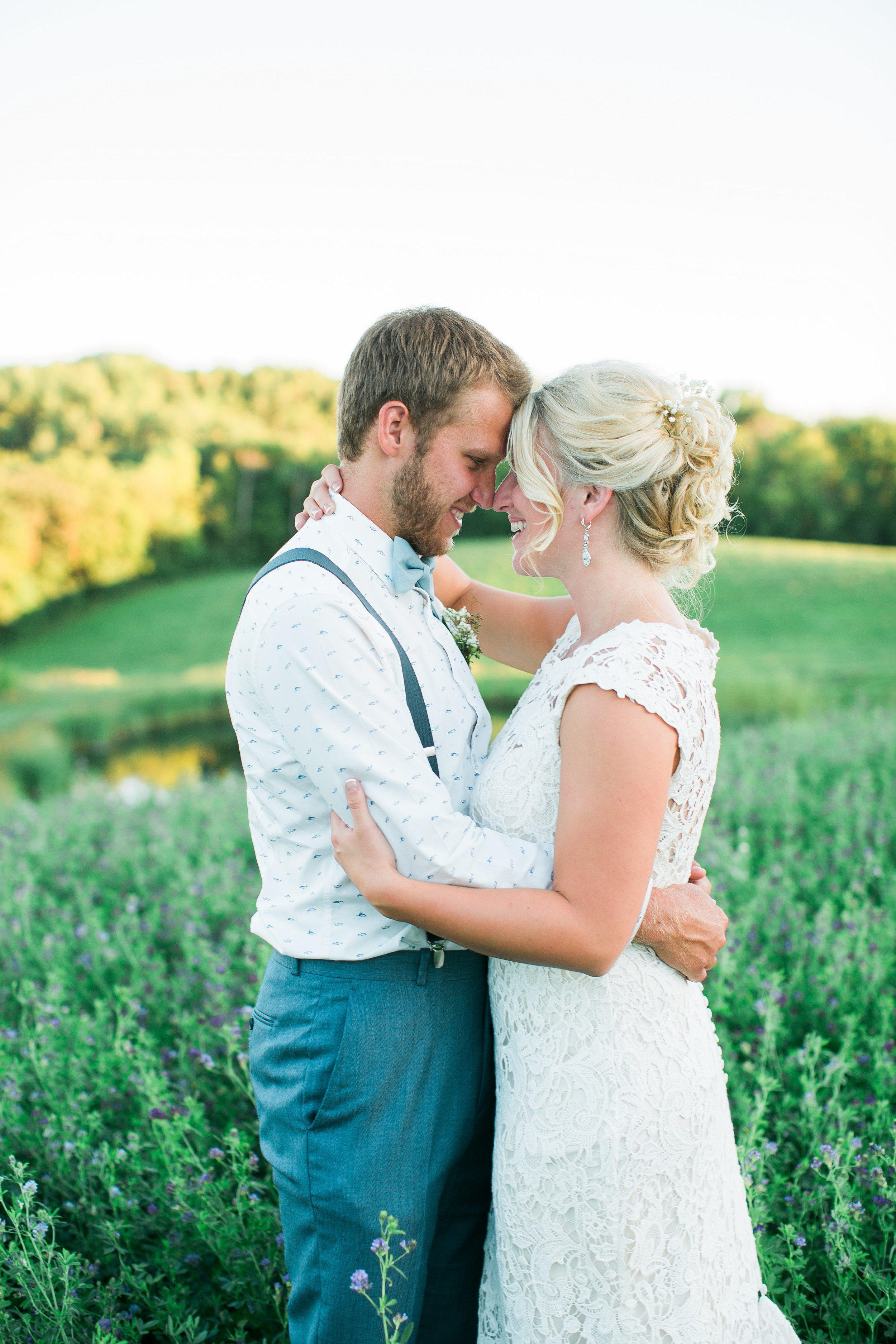 Minnesota rural wedding bride and groom embracing in field Outpost Center wedding Minnesota wedding photography Mallory Kiesow Photography