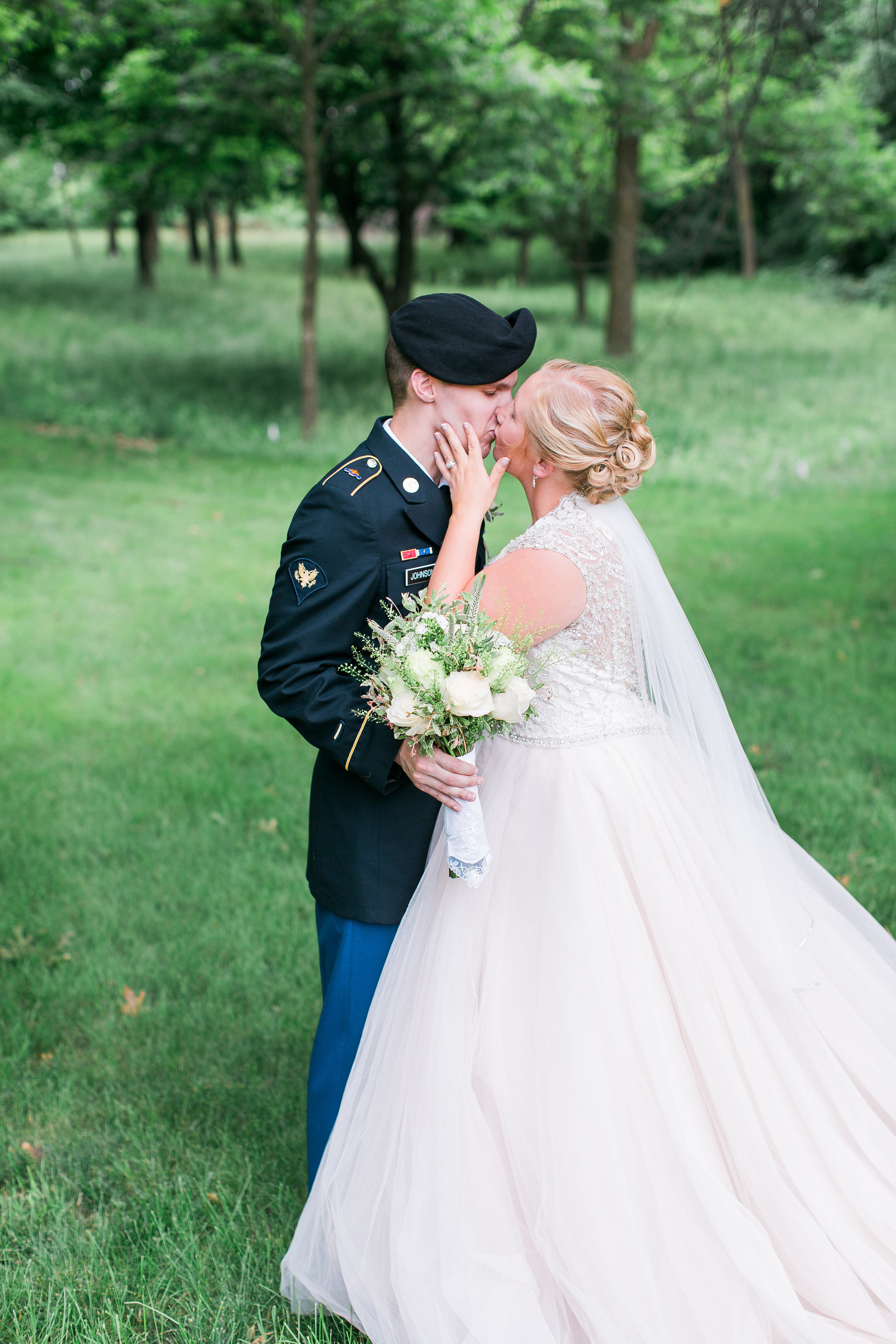 Minnesota military wedding blush gown bride and groom kissing Minnesota wedding photography Mallory Kiesow Photography