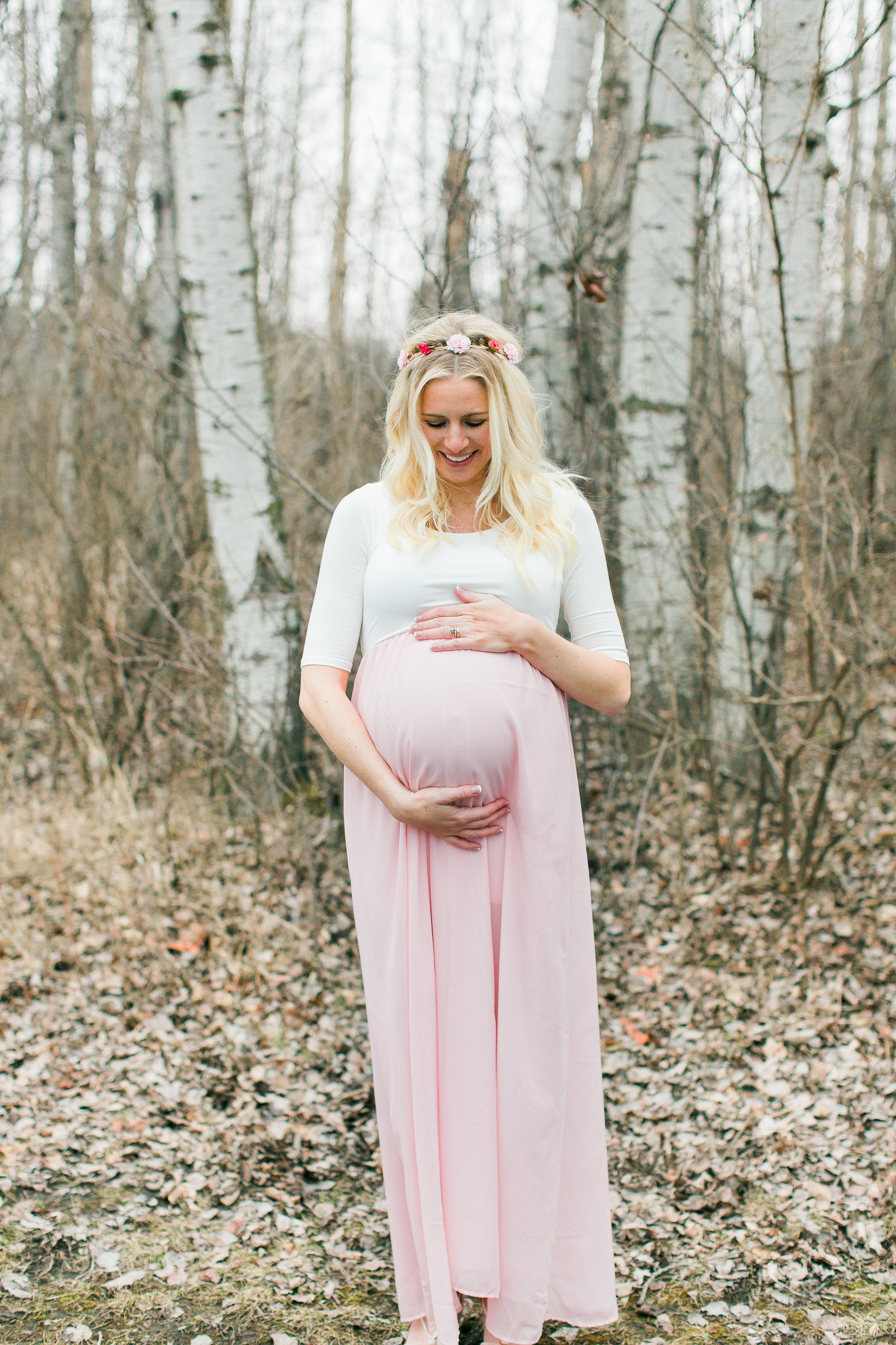 Minnesota maternity photograph of mom in pink dress and flower crown Minnesota matenrity photographer Mallory Kiesow Photography